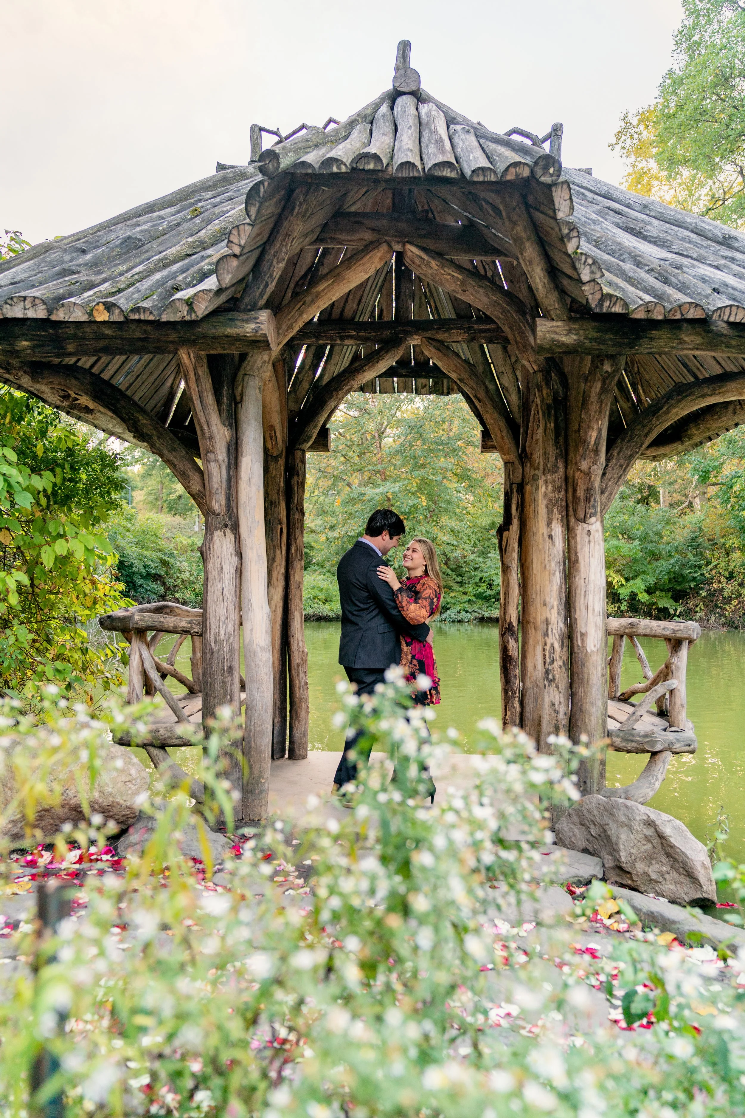 A couple embracing and smiling at each other at Wagner Cove after a proposal