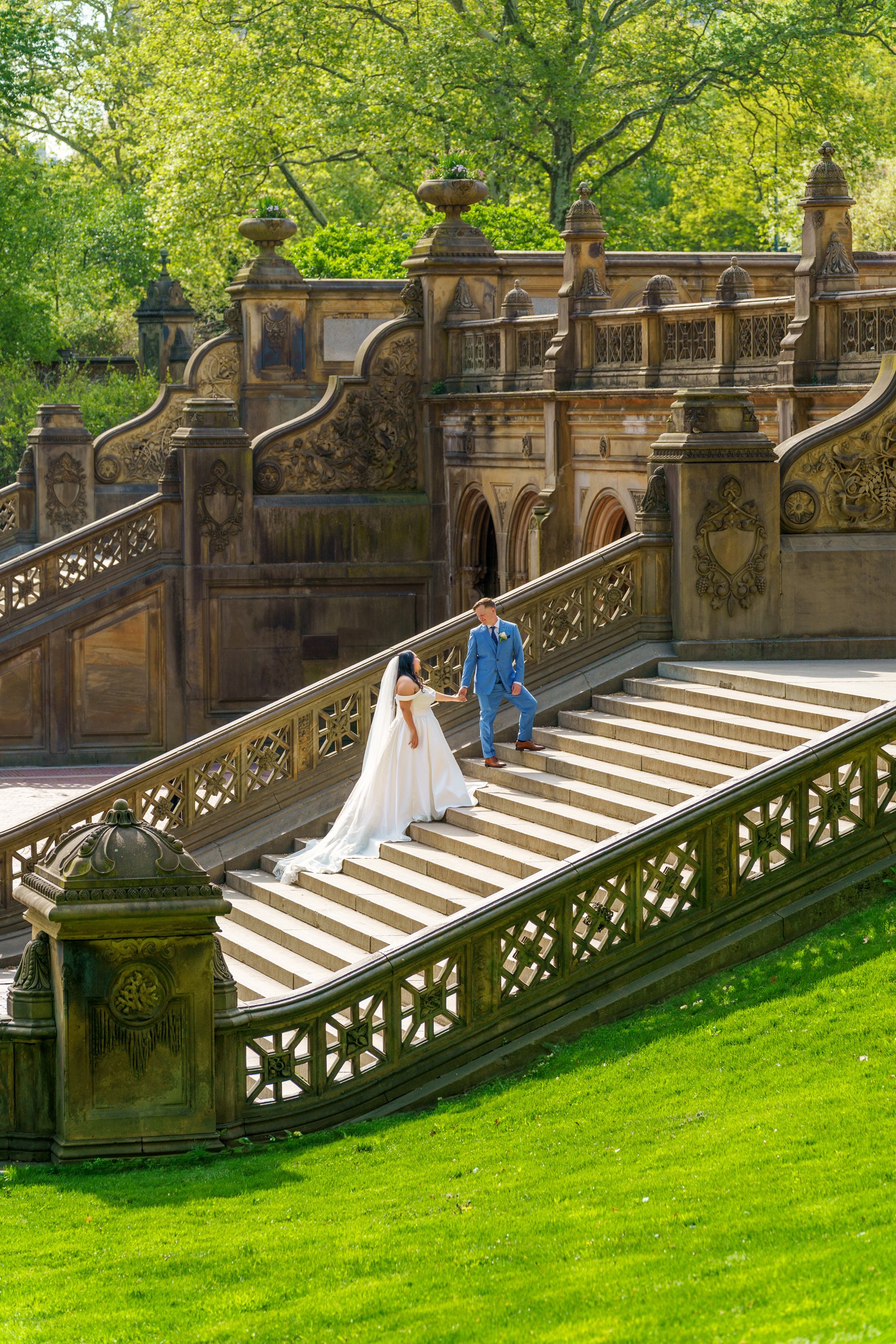A bride and groom on the stairs of the Bethesda Terrace on their wedding day