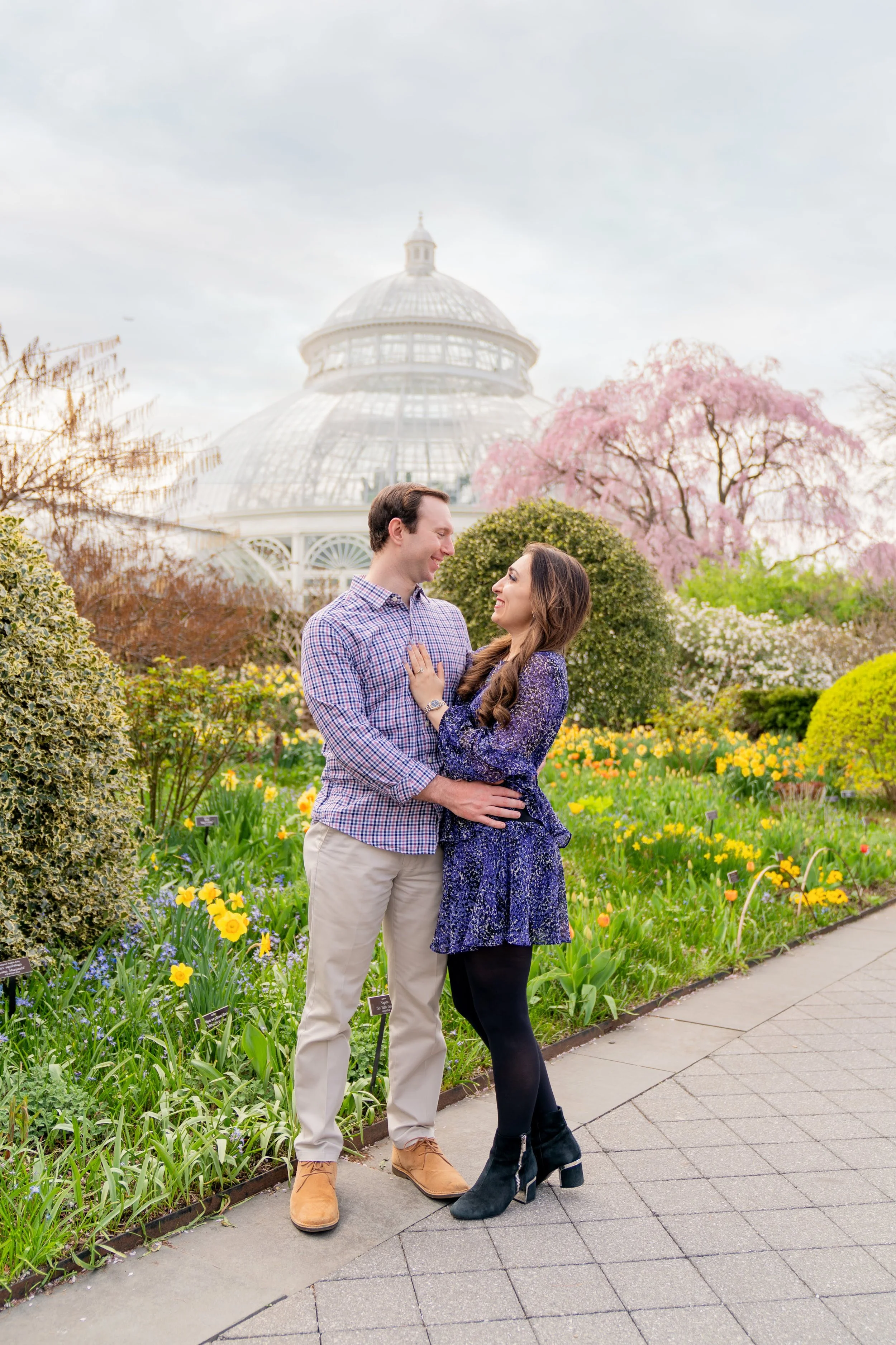 A couple posing in front of the Haupt Conservatory at the New York Botanical Garden

NYBG proposal photographer