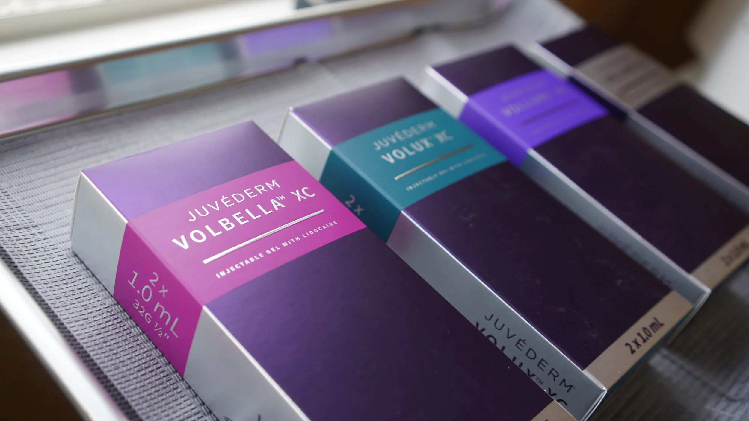 Close-up of a person receiving a lip injection from a medical professional wearing black gloves.