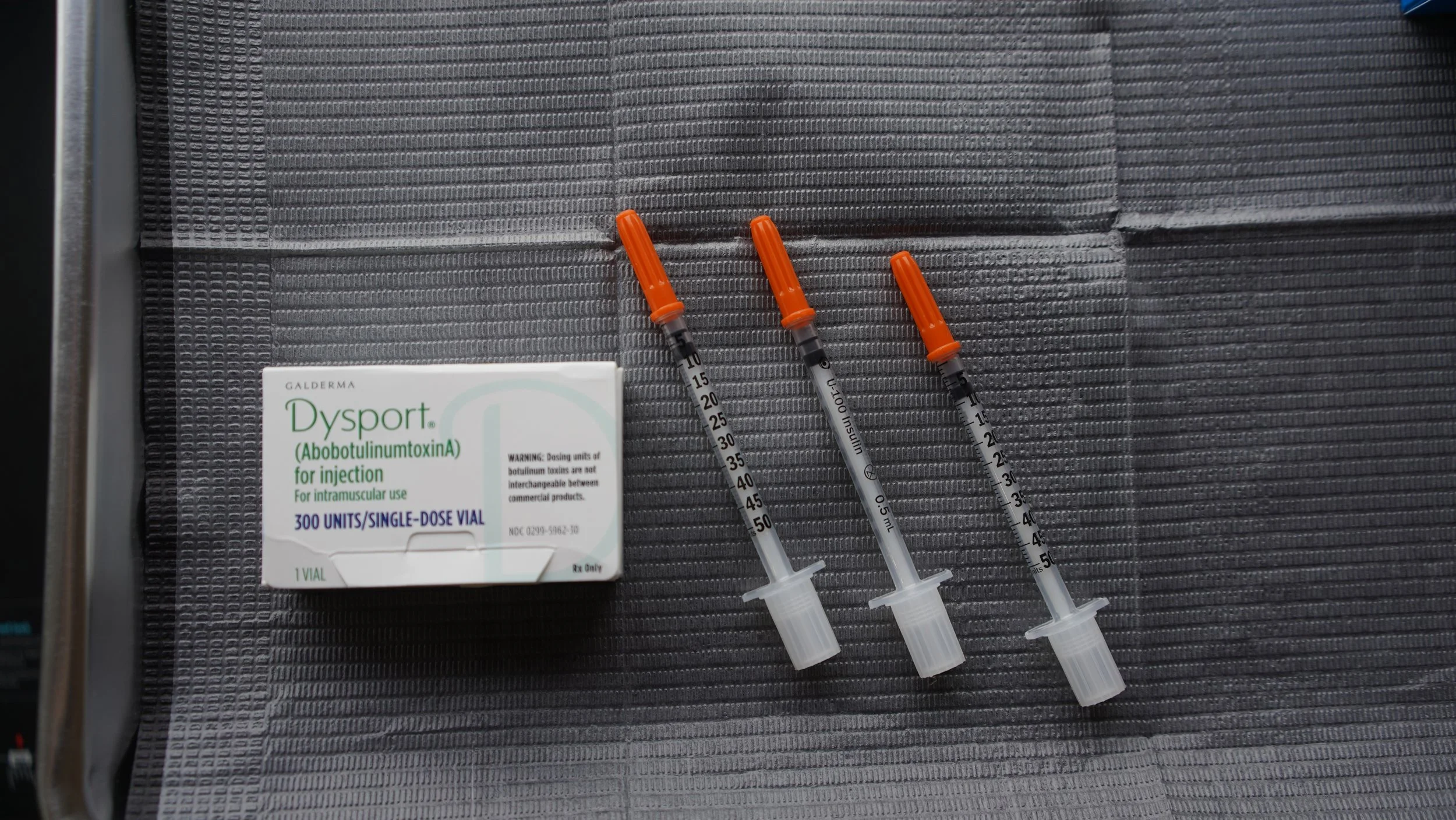 A woman receiving an eyebrow injection cosmetic procedure.