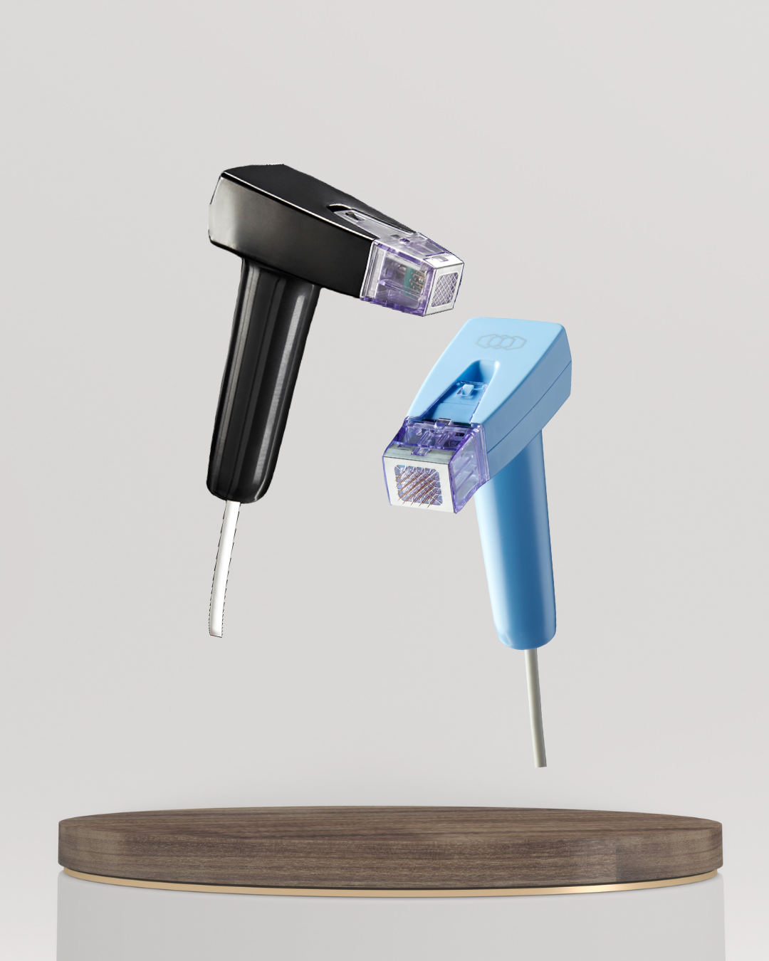 Two internet routers, one black and one blue, floating above a wooden surface.