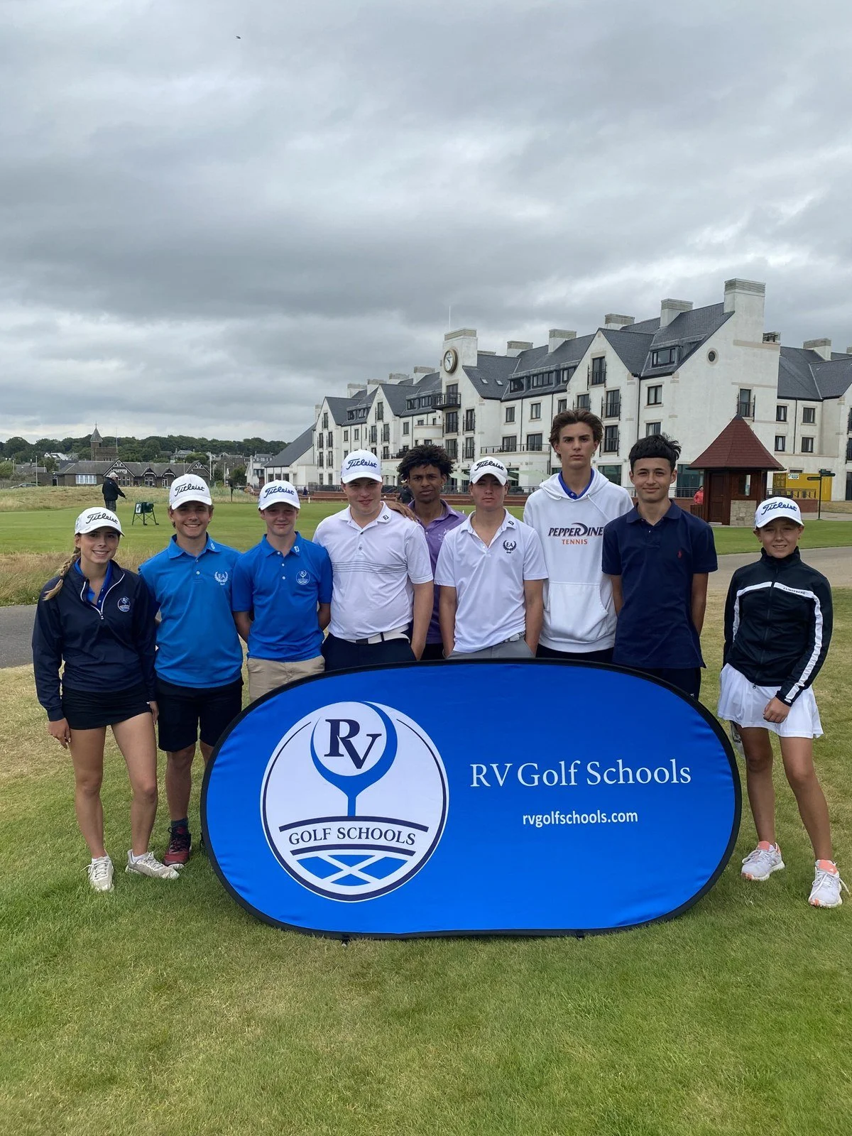 Junior golfers with the RV Golf Schools banner at the 2024 St Andrews camp