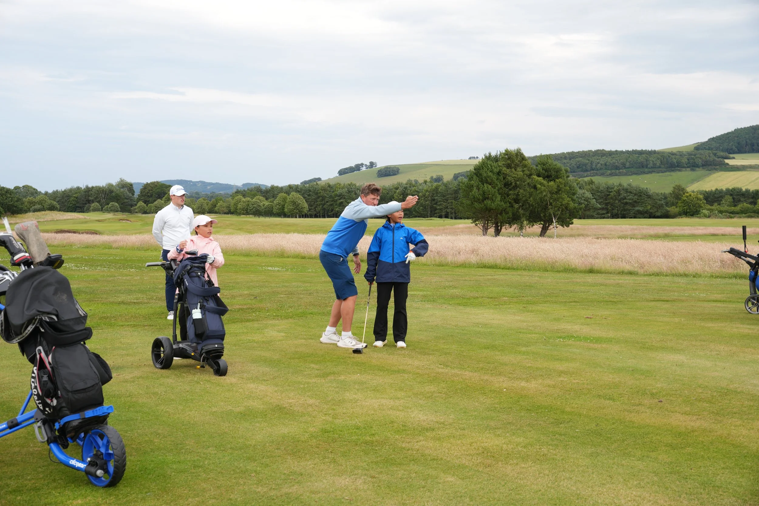 Young junior golfers enjoying a coaching session at RV Golf Schools summer golf camp in Scotland.