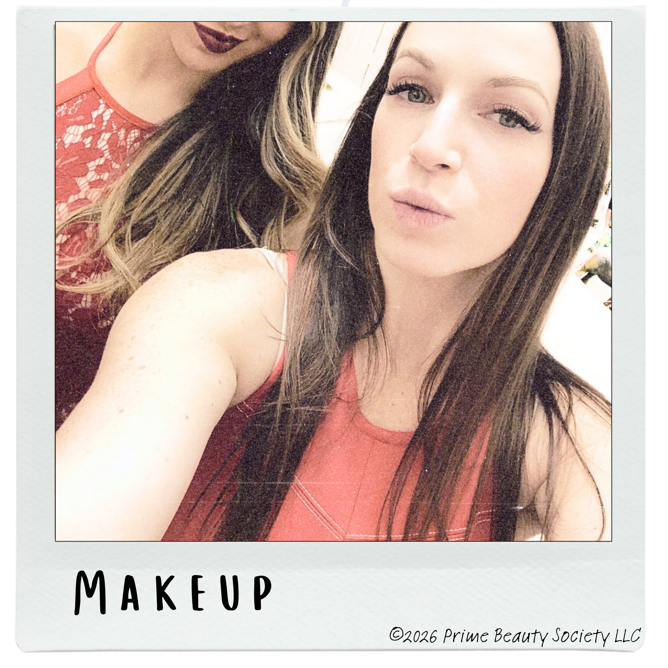 Two women taking a close-up selfie, with one woman in the foreground wearing makeup and a sleeveless top, and the other woman partially visible in the background wearing a lace top.