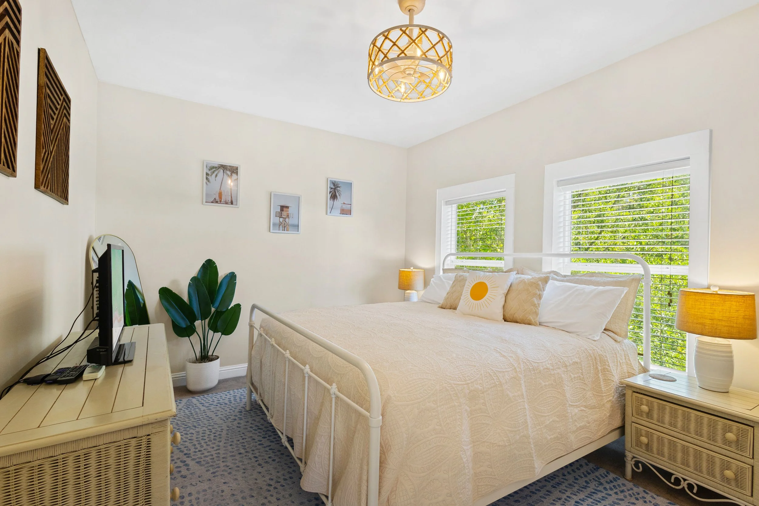 Cozy king bedroom at Salty Surf near Gulf Place on 30A with coastal decor, plush bedding, and a private en-suite bathroom