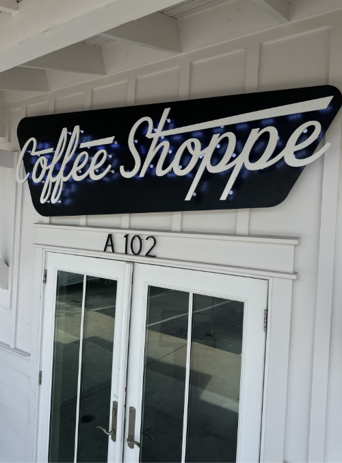 Sign reading "Coffee Shoppe" above a door with the room number A102.
