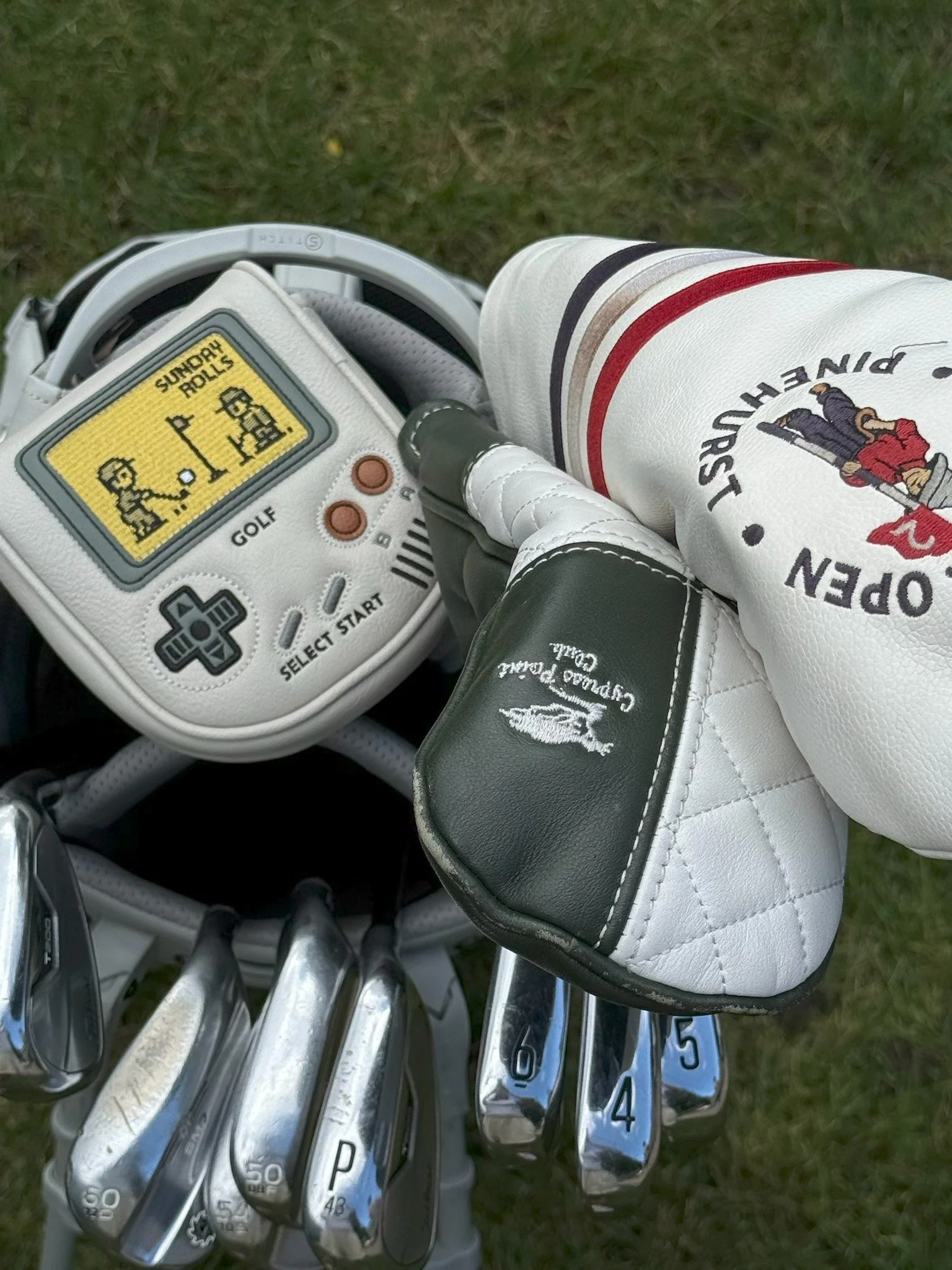 Premium center-shafted Sunday Rolls golf putter headcover featuring a unique retro gaming design on a putter within a golf bag.