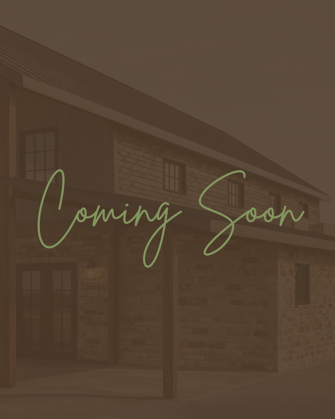 People gathered outside a rustic wooden barn with large windows during a social event, possibly a wedding reception, on a clear day.