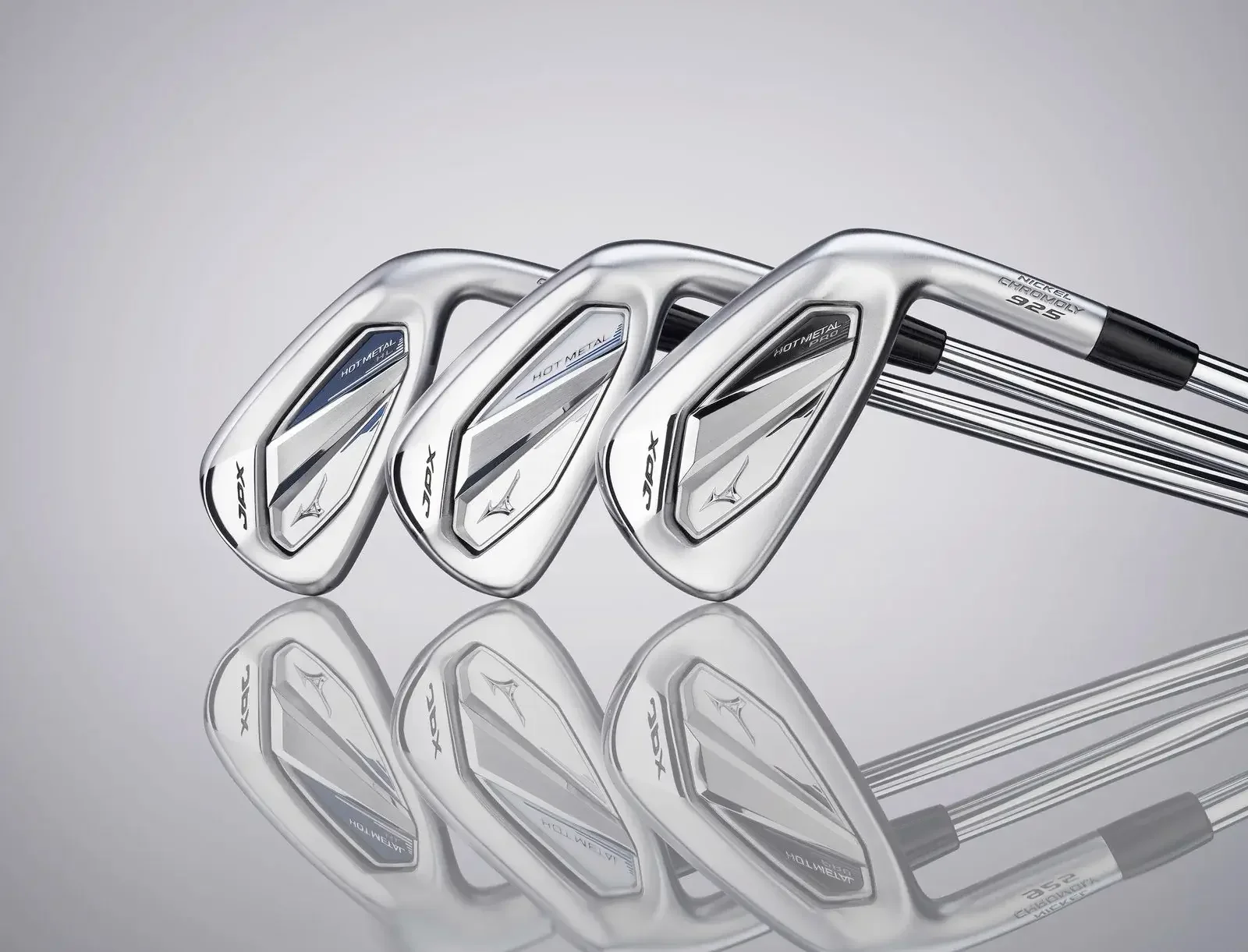 Three Mizuno golf irons with reflective surface and their reflection beneath on a smooth surface.