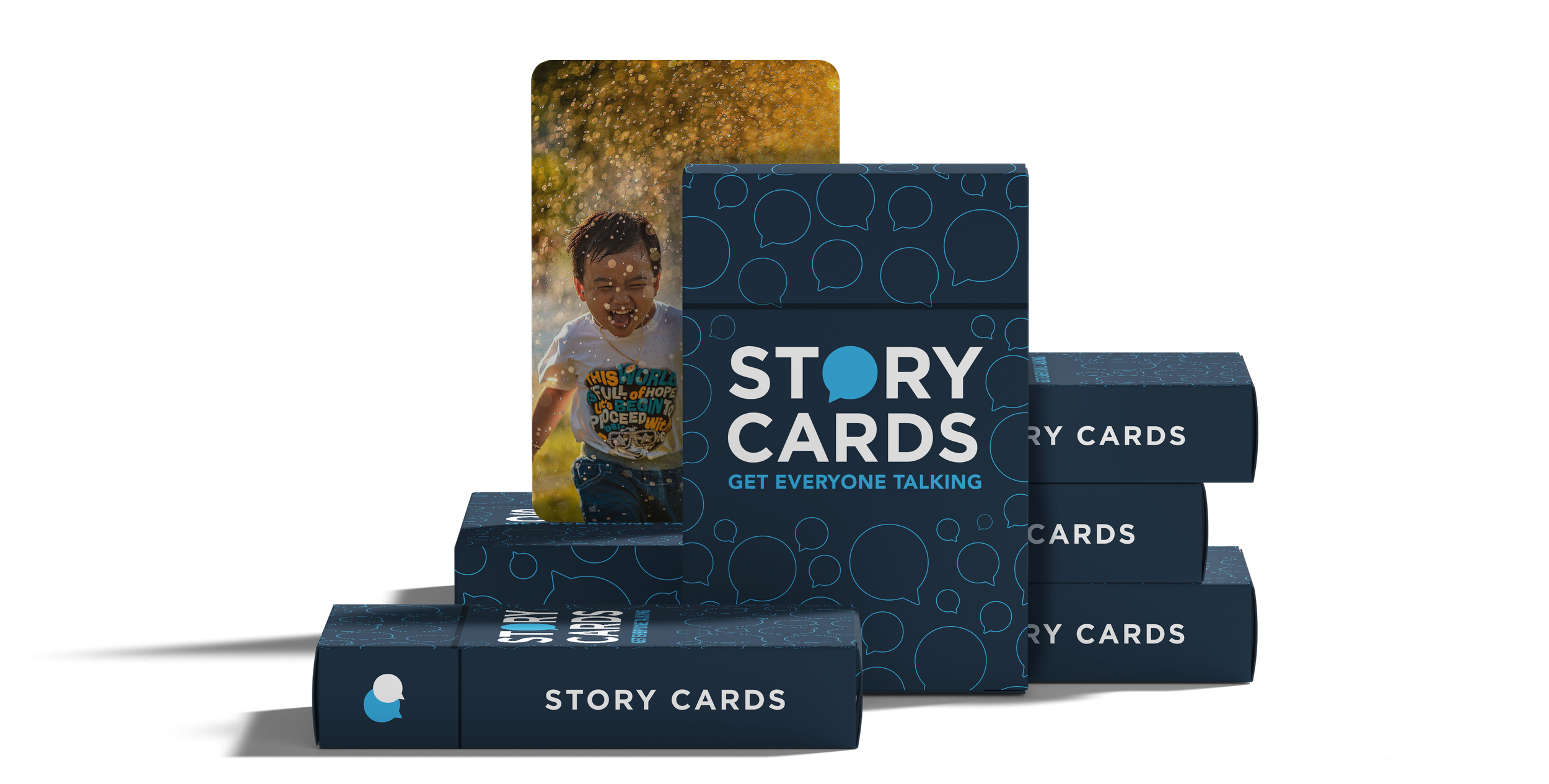 Stack of story card boxes with a sample card showing a smiling boy outdoors, with trees and sunlight in the background.
