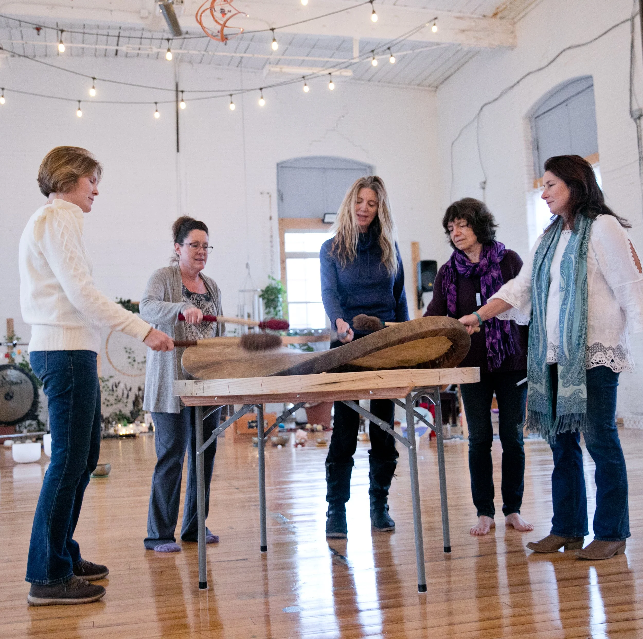 Laurie’s customers, Mariana and Carmen holding hands on a green lawn on their wedding day.