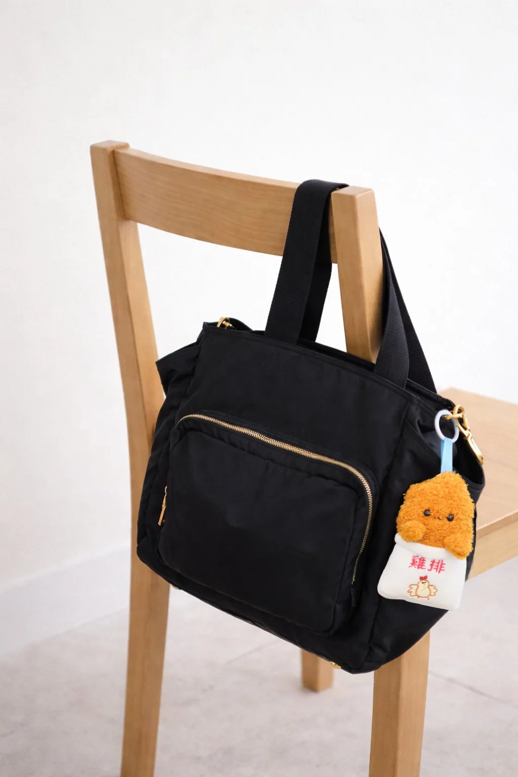 Ji pai charm on black back on wooden chair