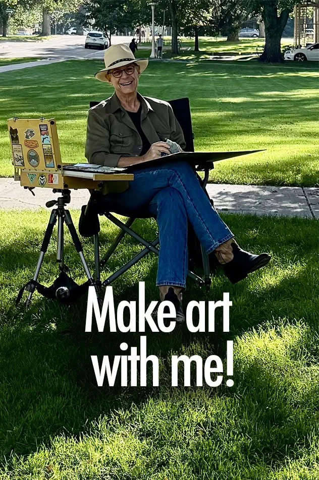 An elderly woman sitting outdoors on a grassy area, wearing a hat, glasses, and casual clothing. She is smiling and sitting beside an art setup including a small wooden easel and a laptop. The background shows trees, parked cars, and a sunny day. Text on the image reads: 'Make art with me!'