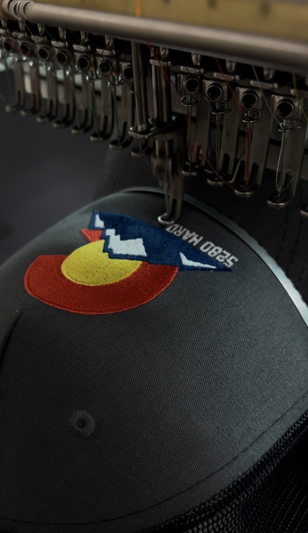 Close-up of a hat being embroidered.