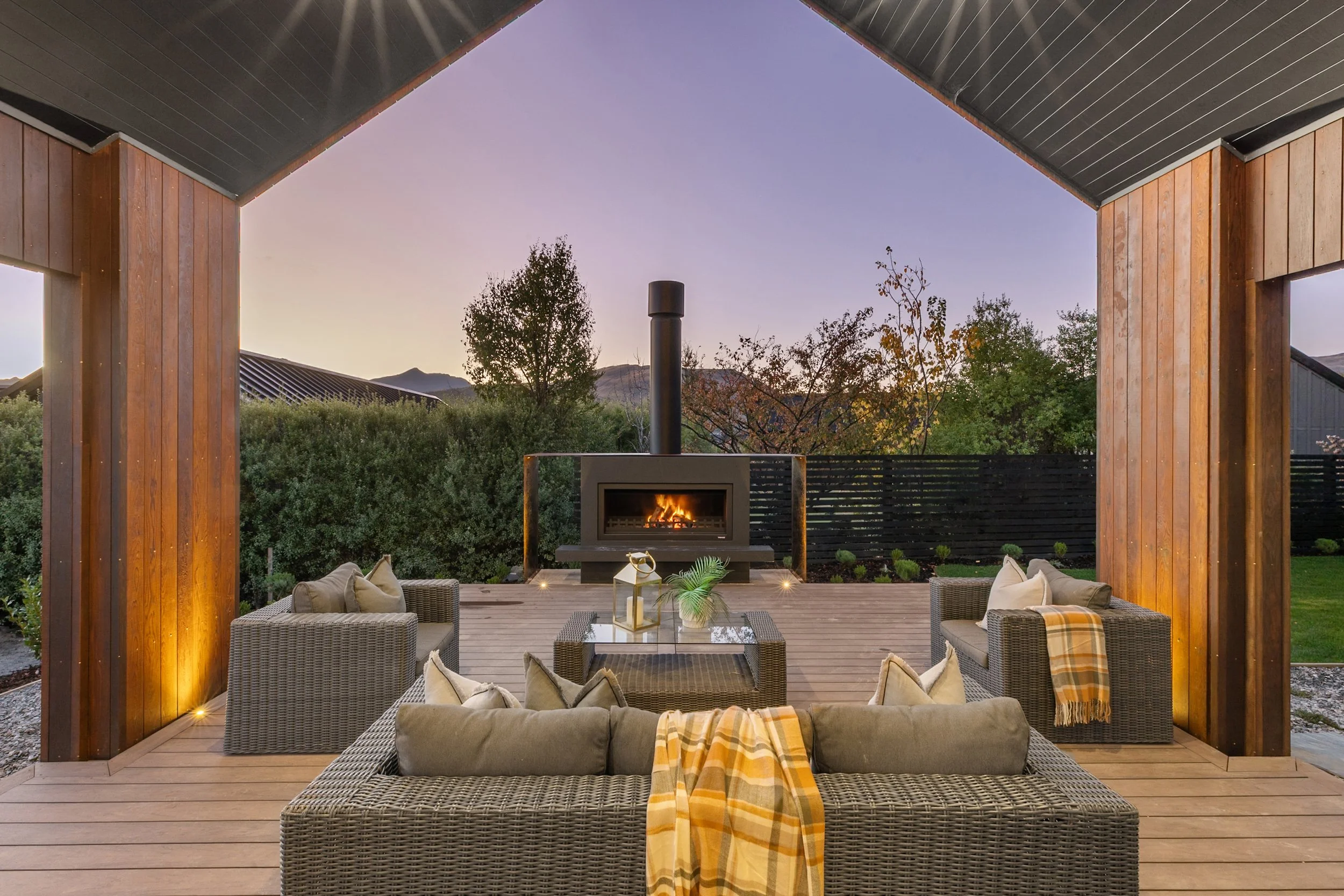 New build outdoor patio with fire pit and mountain views at sunset — Jacks Point, Queenstown