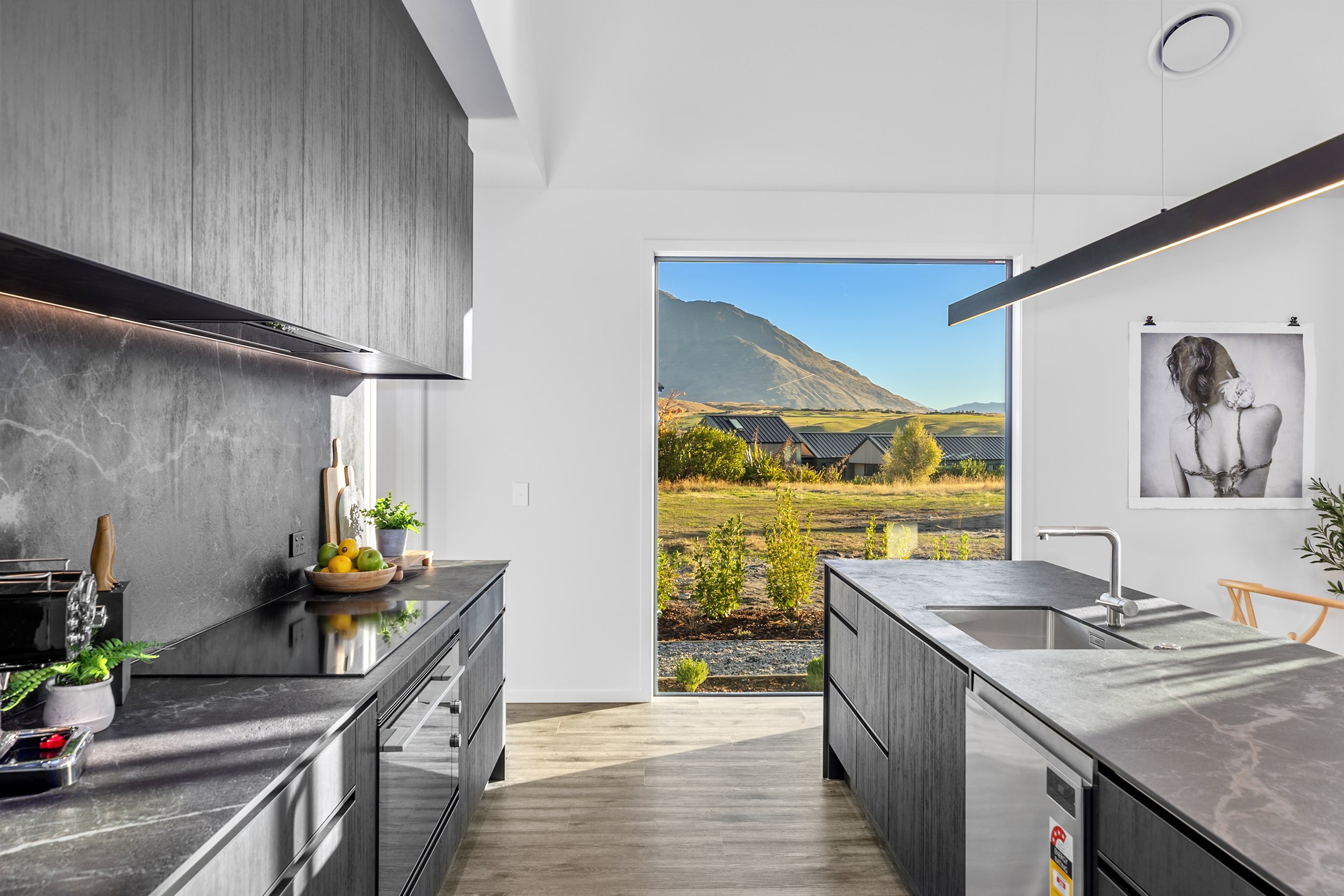 New build kitchen with grey cabinets, marble countertops, and mountain views — Jacks Point, Queenstown