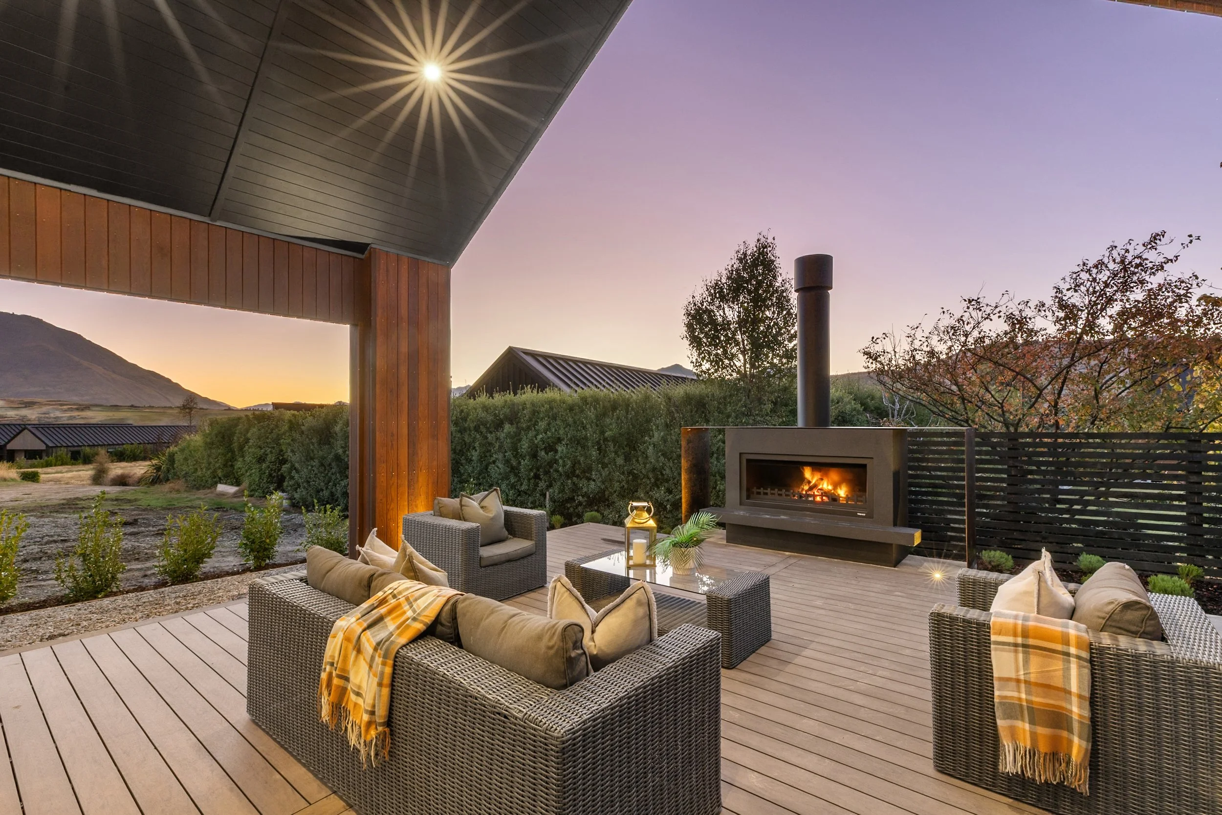 New build outdoor patio seating area with fire pit at sunset — Jacks Point, Queenstown