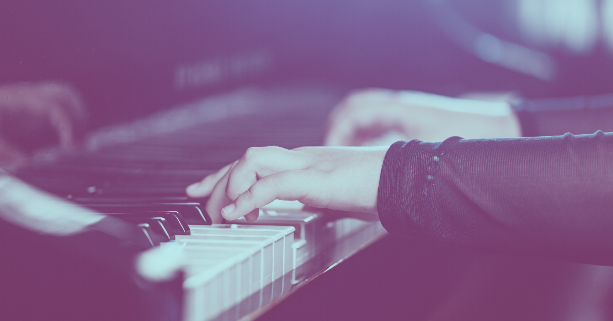 Close-up of a person's hands playing a piano, with a purple overlay.