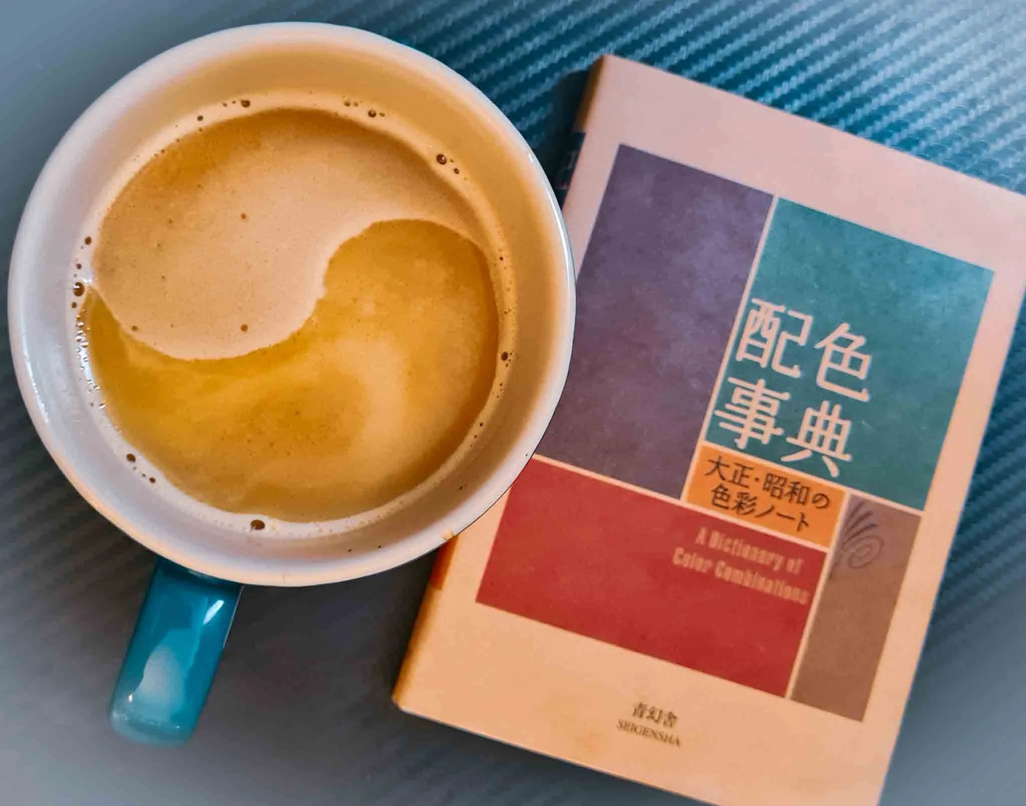 Artist Shanti Padme's coffee cup with yin yang symbol on top