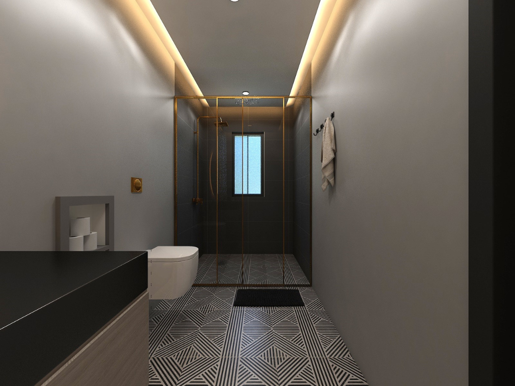 Modern bathroom with a walk-in shower, wall-mounted toilet, and geometric patterned floor tiles.