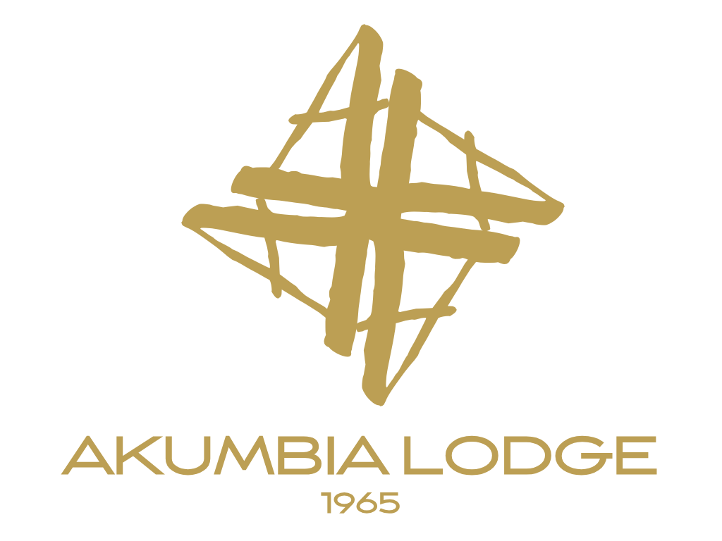 A stylized gold logo resembling a star or a geometric design, with the text "AKUMBI LODGE 1965" in gold below it on a black background.