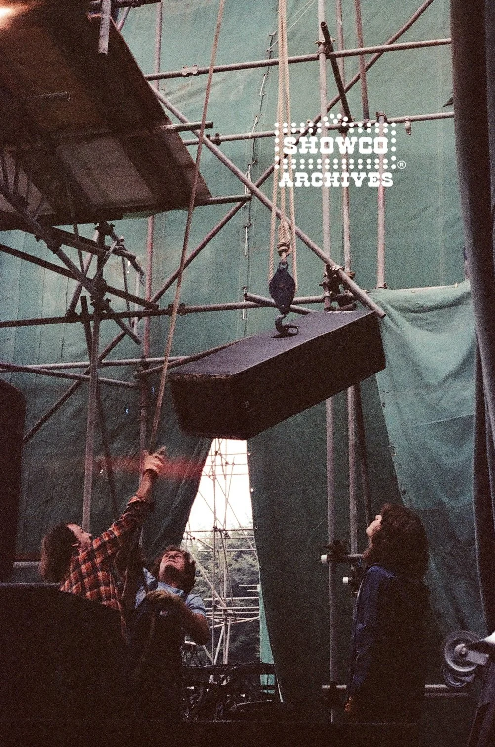 Craig Schertz, Johnny 'JW' Roberts, Dale Polansky hoisting a Showco speaker stack during setup at Summertime Open Air Festival, Ulm, Germany, 1978. Courtesy of the Showco Archives.