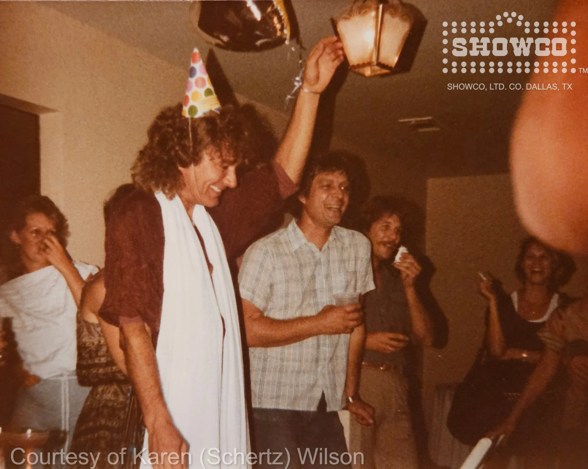 Robert Plant celebrates his birthday at the Schertz family home in Dallas while friends and Showco crew look on. Courtesy of Karen (Schertz) Wilson.
