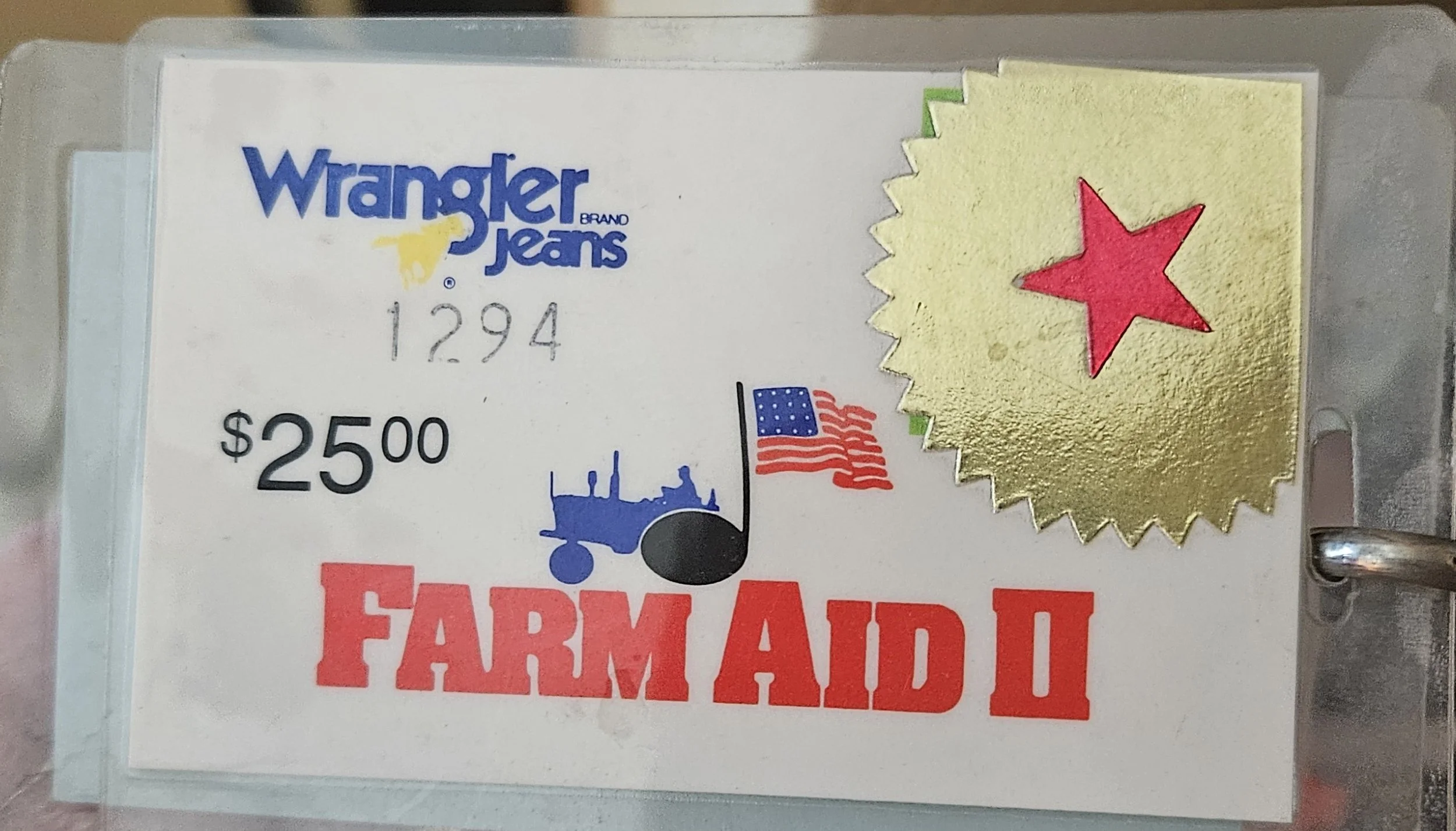 Farm Aid II laminated pass, 1986, with Wrangler branding, a $25 face value, and a red-star sticker.