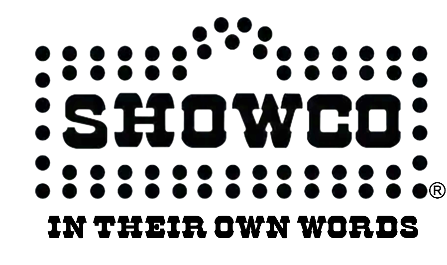 A dark pinball or arcade game machine with colorful lights and the text 'SHOWCO' prominently displayed on the front. The image has a gaming or entertainment theme with light reflections and decorative elements.