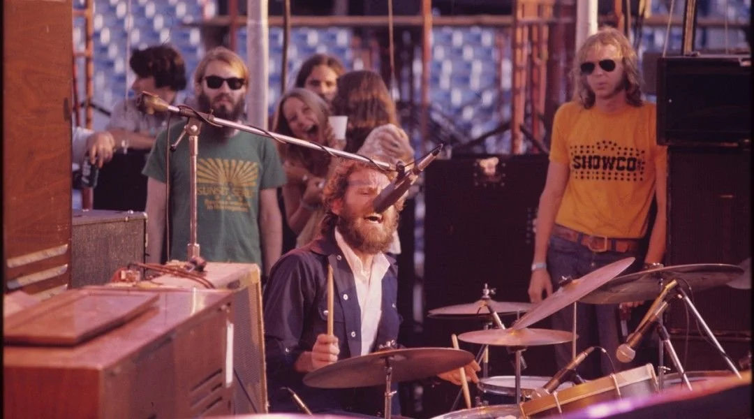 alum Ted Tittle in Showco shirt watching Levon Helm (The Band)