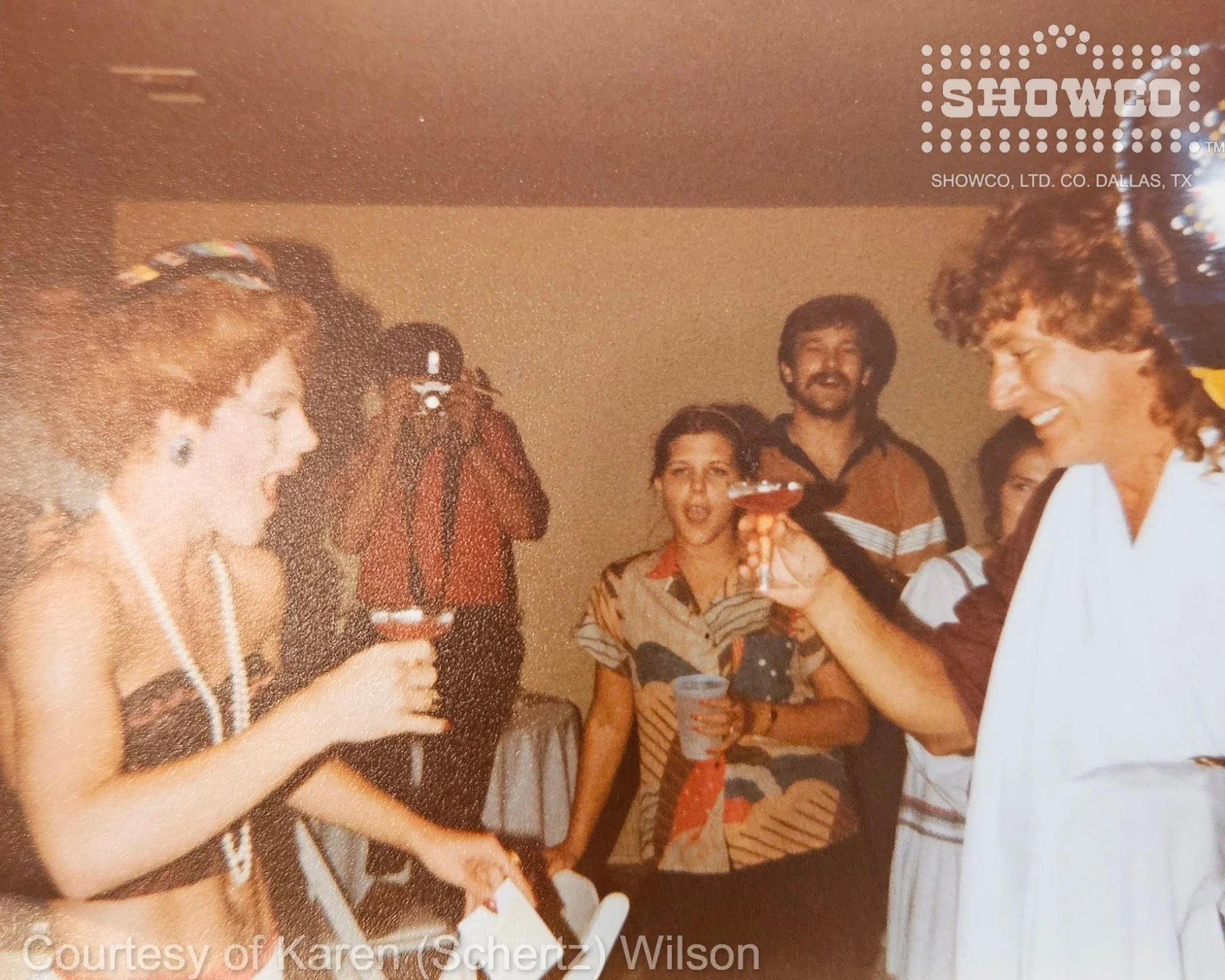 The birthday toast continues as everyone enjoys the unexpected entertainment.