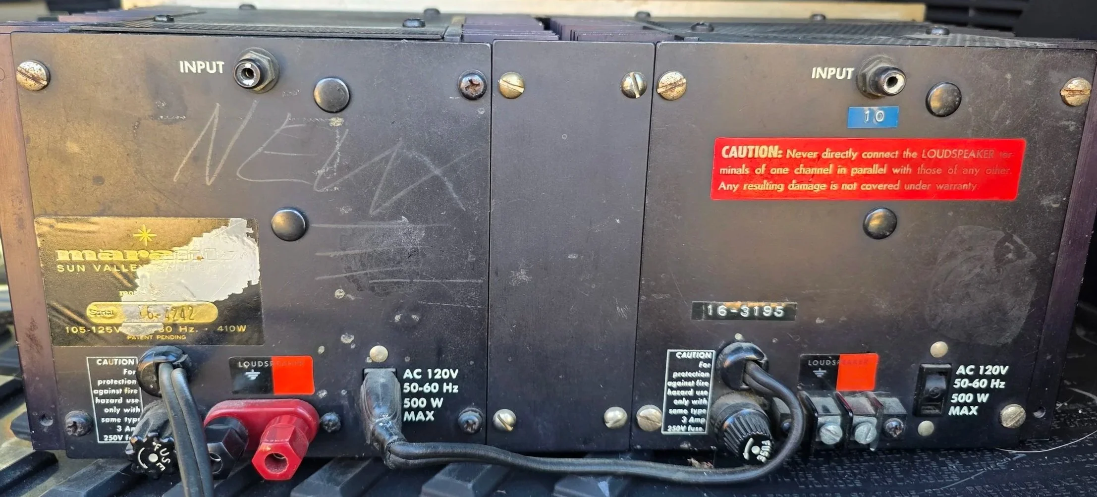 Back of Marantz 16b audio amplifier with input ports, warning labels, and power connections.