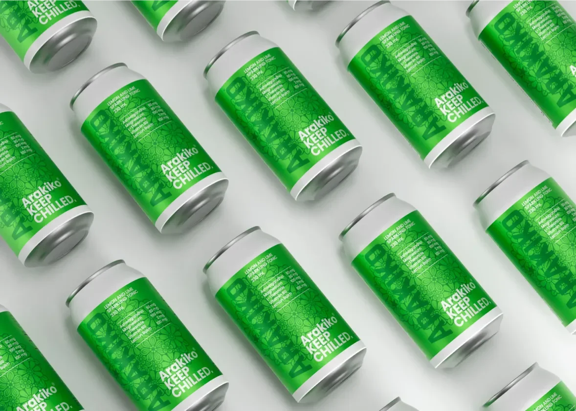 Multiple cans of Arakiko Lemon and Lime Sparkling Tonic arranged on a white surface.