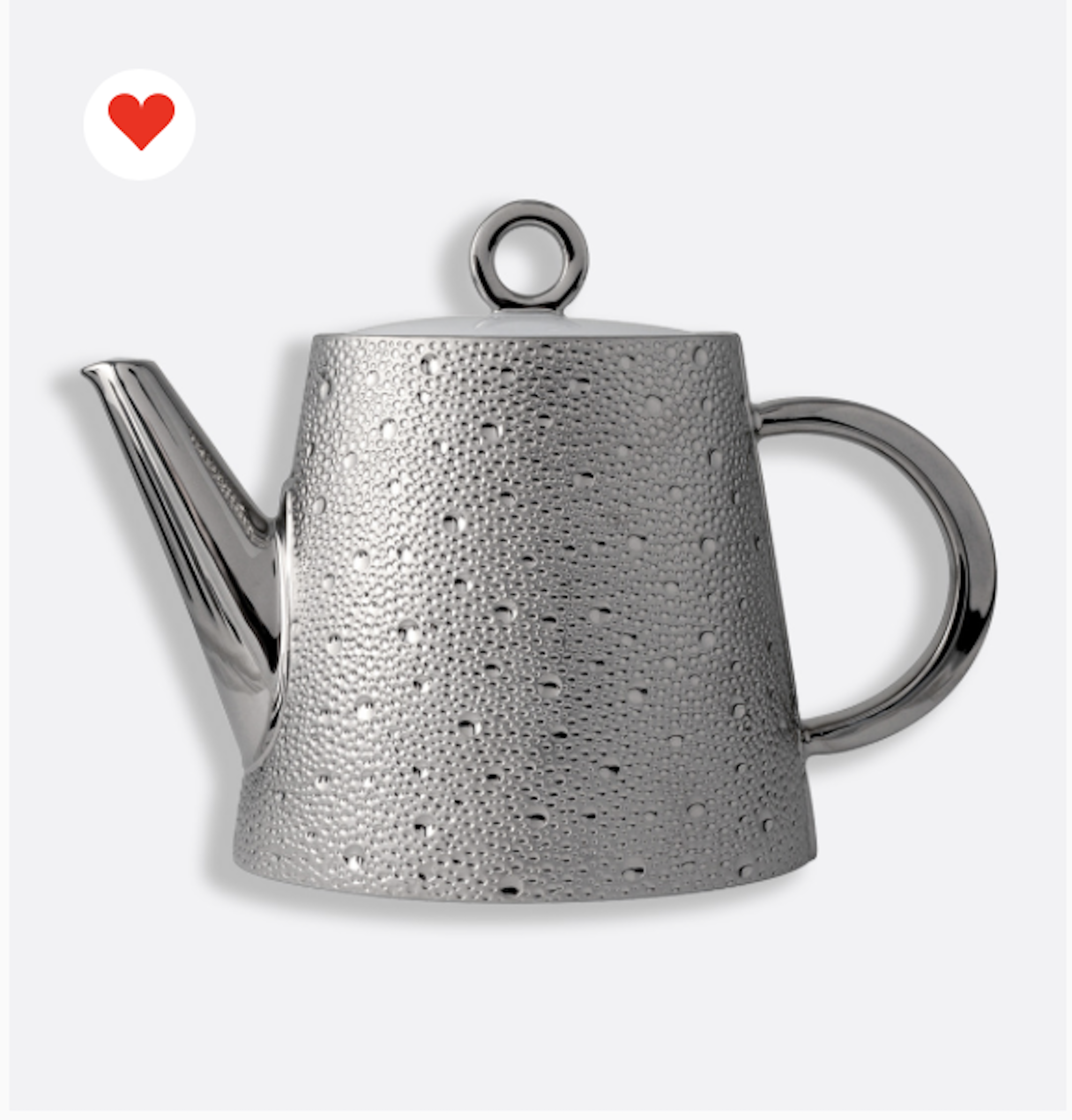 A metallic teapot with water droplets on its surface, seen against a plain background.