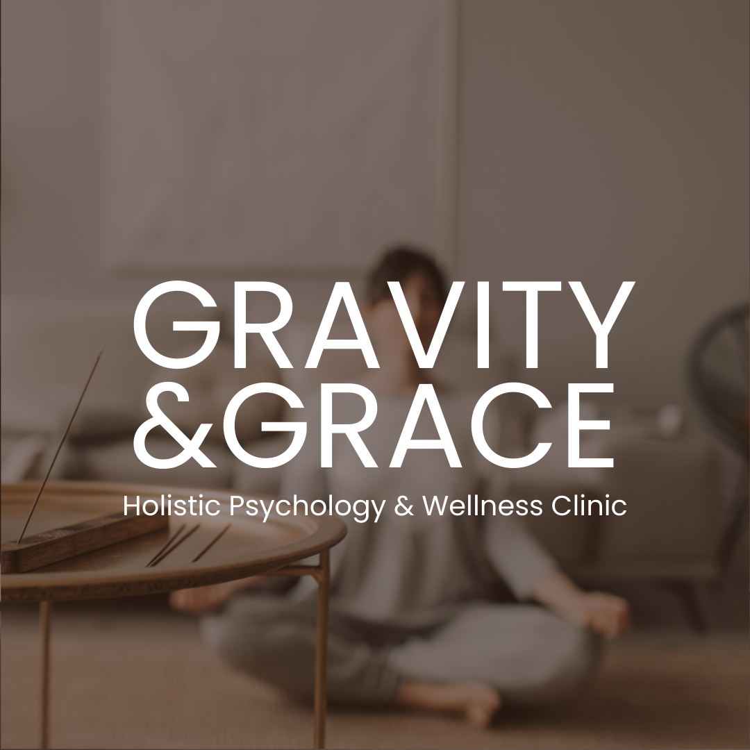 Blurry image of a person sitting on the floor, with a wooden tray with incense sticks in foreground. Text overlay reads 'Gravity & Grace Holistic Psychology & Wellness Clinic.'