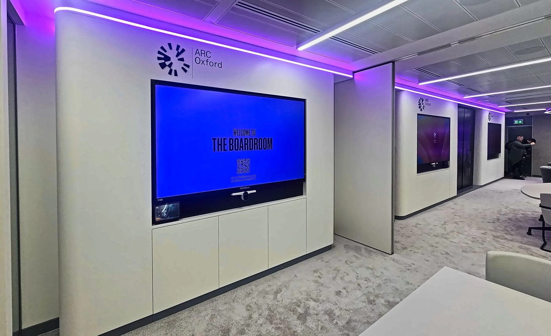 Digital signage screen on a feature wall in an office showroom