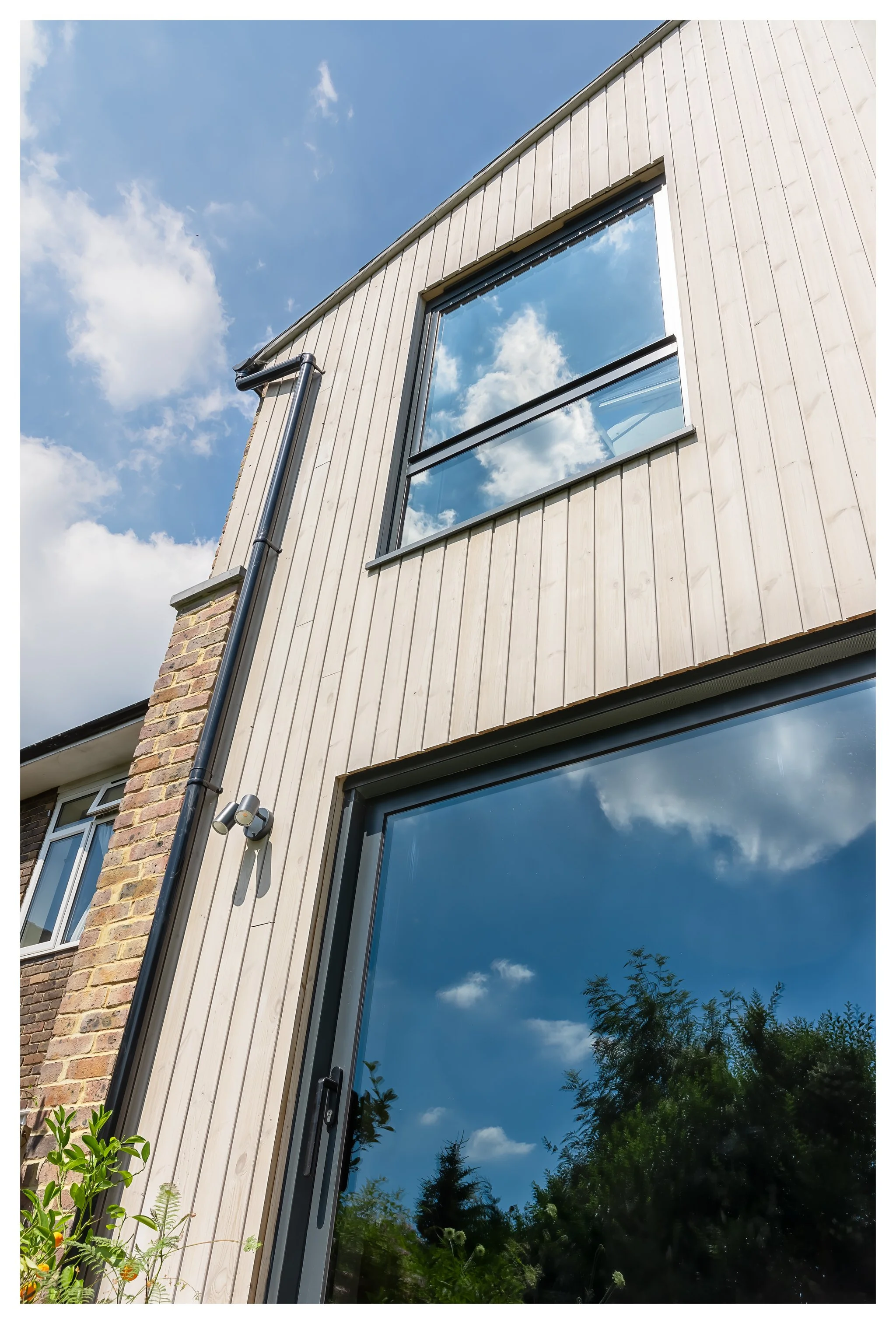 Contemporary garden-facing extension in Winchester by Tobias Weaver