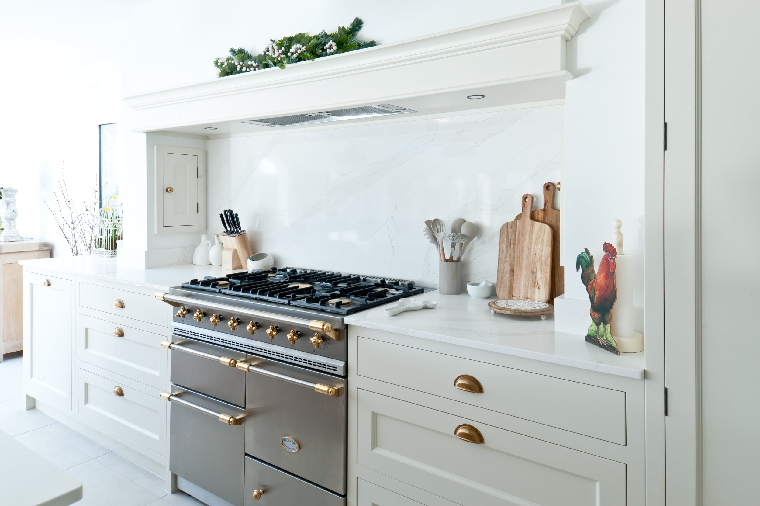 Luxury Lacanche range cooker with brass detailing, white shaker cabinetry and quartz splashback by Collins Bespoke Kent.