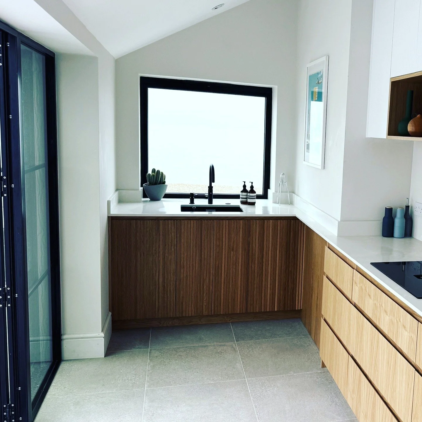 Clean lines. Natural textures. Sea views for days 💙

This bespoke coastal kitchen blends calm design with timeless craftsmanship.
#CollinsBespoke #BespokeKitchens #ModernDesign #CoastalHome