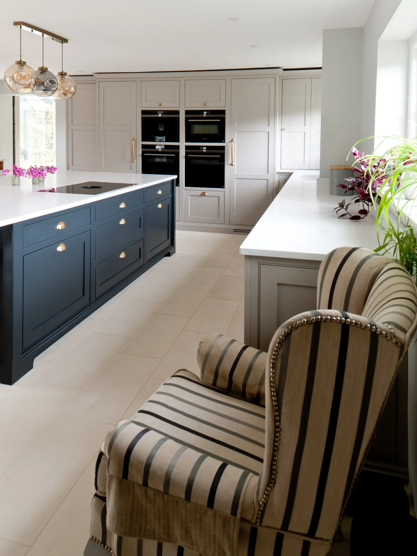 So pretty.

Designed to feel calm, practical and timeless, this kitchen uses natural materials and considered detailing to create a beautiful space that works. It is a beautiful beaded-Shaker, finished in Farrow &amp; Ball's Pavilion Gray and Hague B