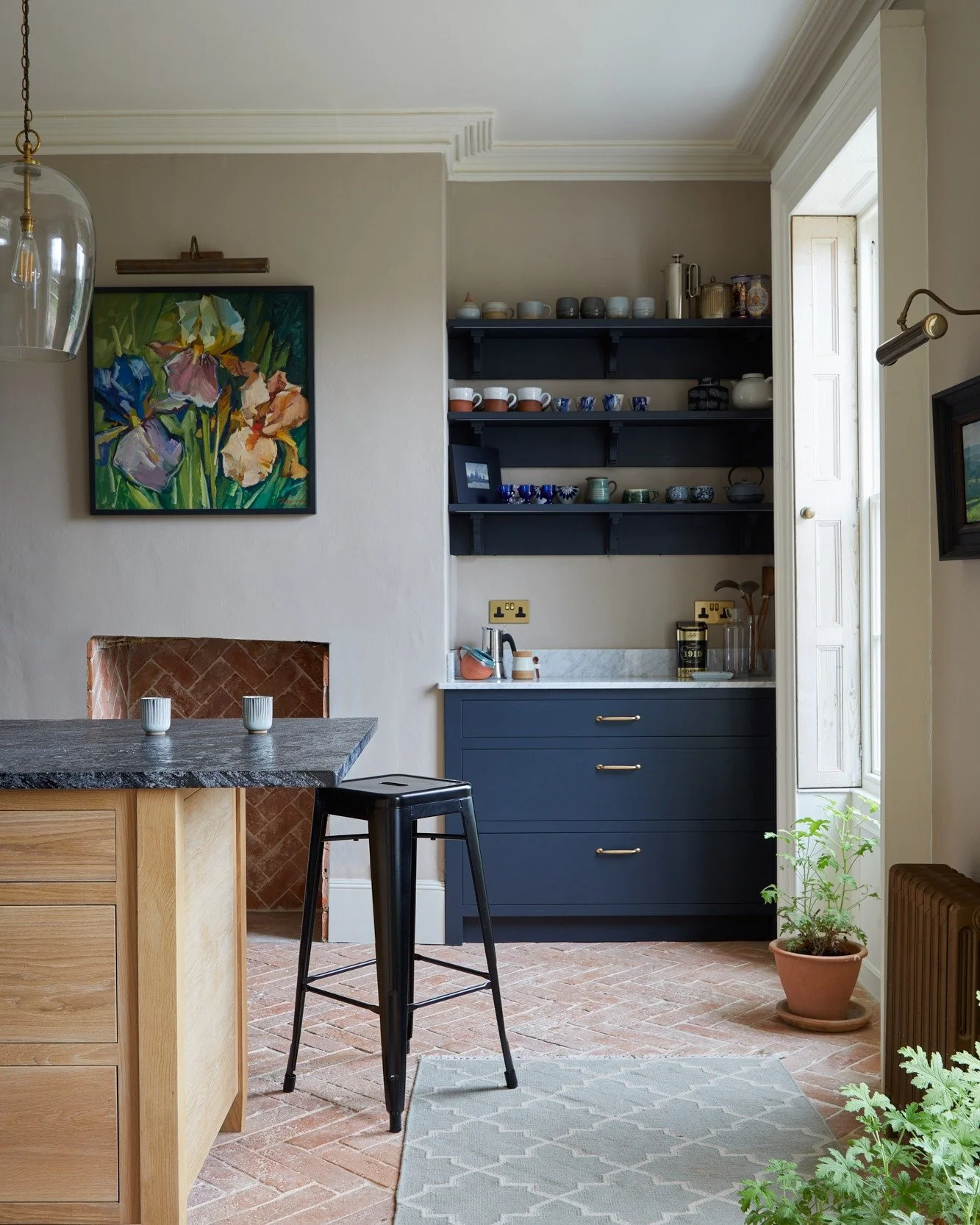 Forever will we love this kitchen. 

Beautiful dark, dark blue cabinets complemented by natural oak - and, so lovingly furnished. Open shelving does give you that chance to show off your crockery, if you want to - and, sometimes, we have cups and mug
