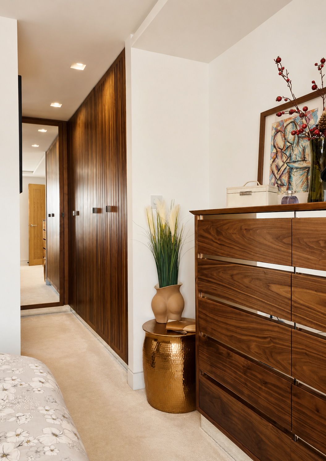 Material girl. Rich walnut fitted wardrobes and bedroom furniture bring warmth, texture and a distinctly contemporary edge.