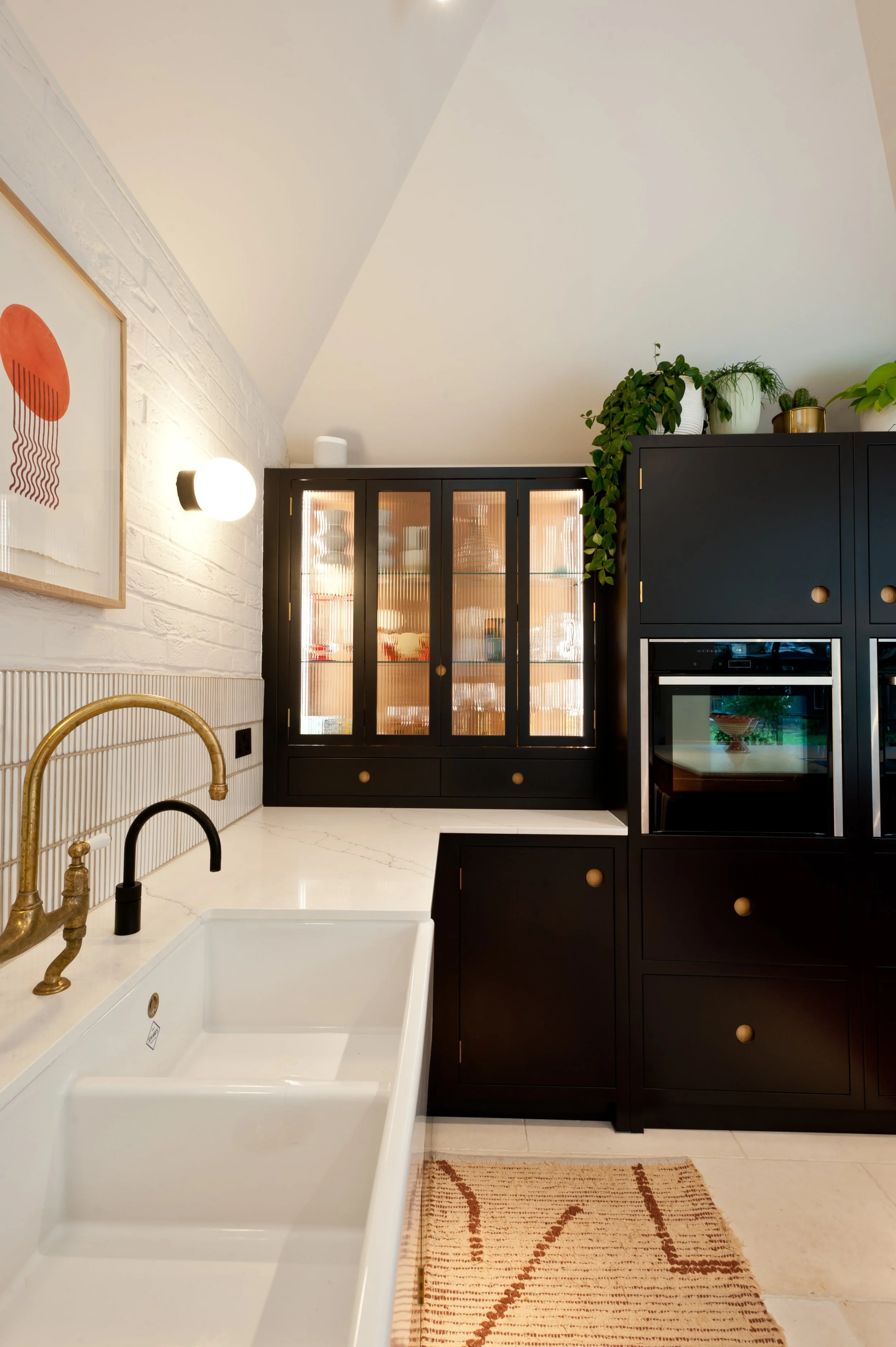 Bespoke dark drinks cabinet with glazed doors and illuminated shelving