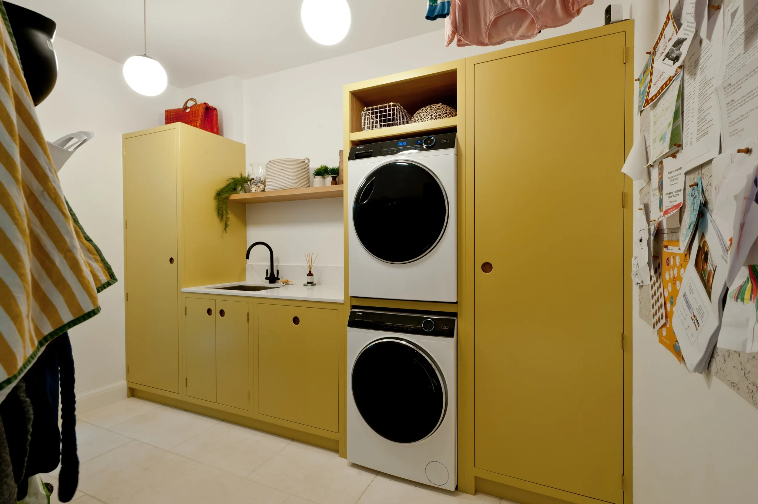 Bespoke utility room cabinetry with integrated laundry appliances in a Margate home