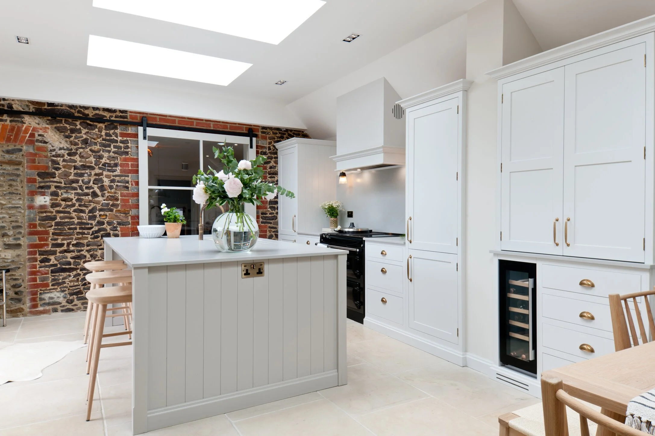 Handcrafted Shaker kitchen cabinetry with quartz worktop, brass hardware and carefully detailed painted joinery.