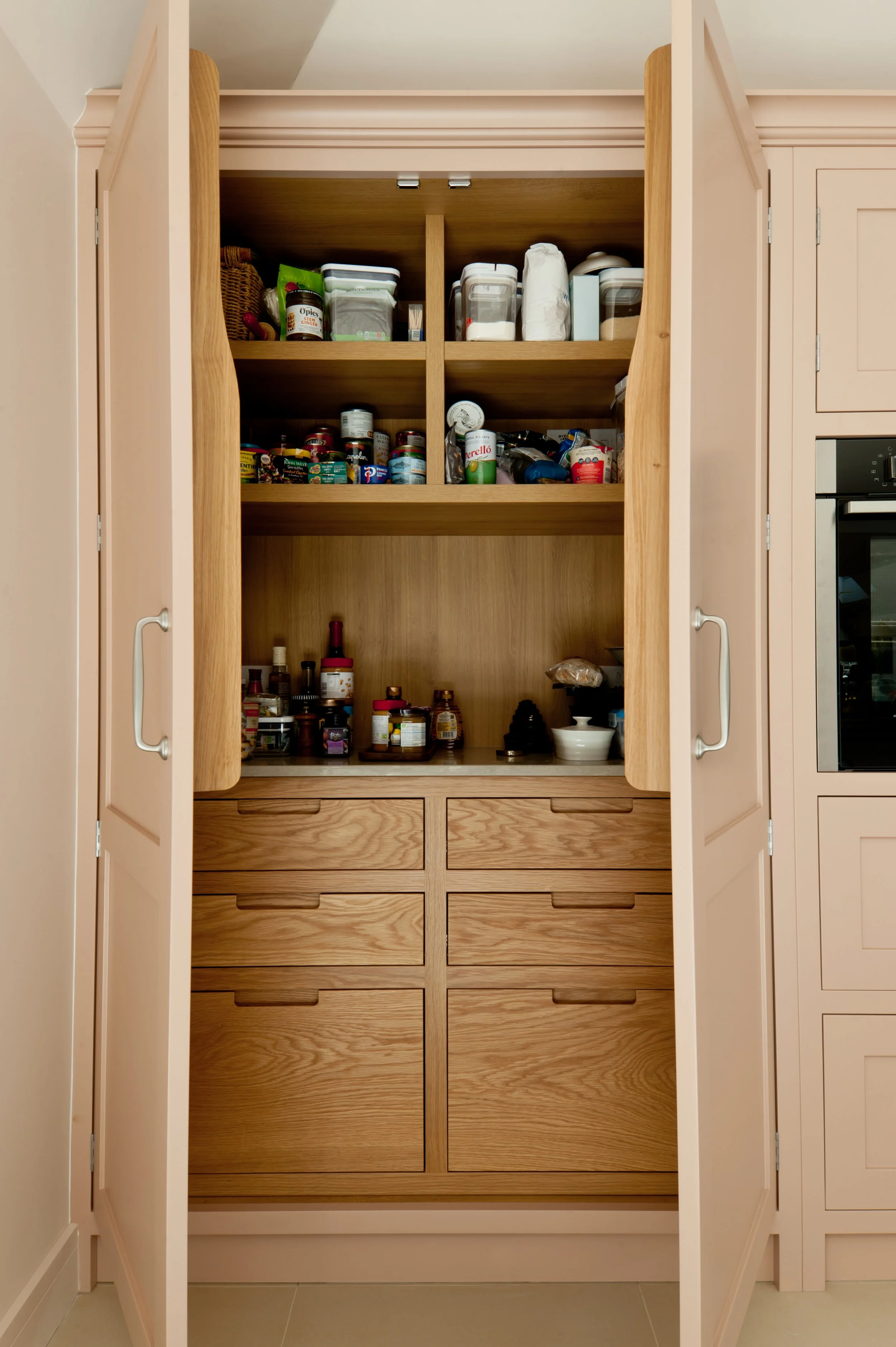 Handcrafted pantry cupboard with oak drawers, internal shelving and bespoke kitchen storage.