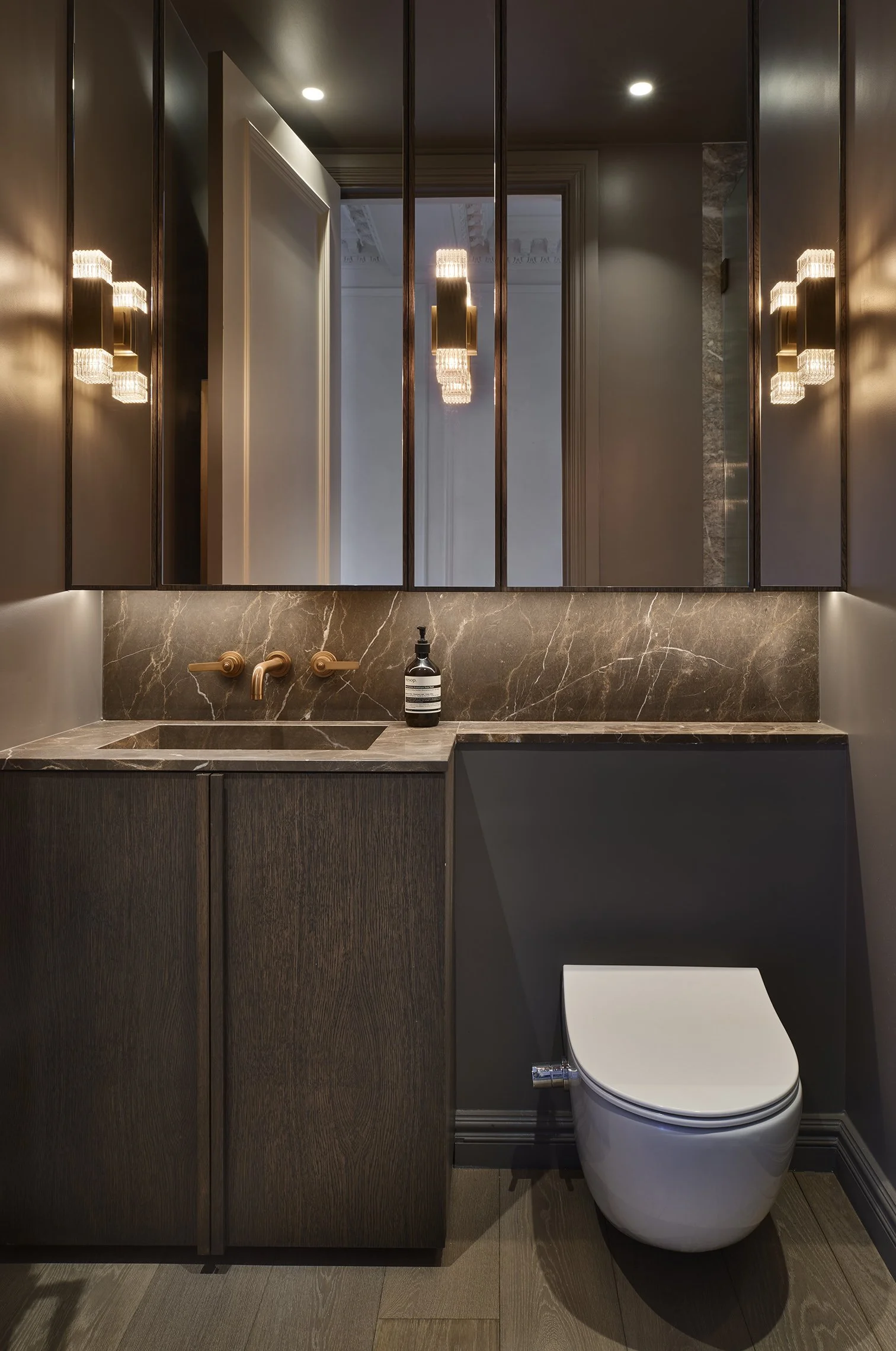 The dark side, done beautifully. Bespoke timber bathroom furniture paired with dramatic marble and warm brass.