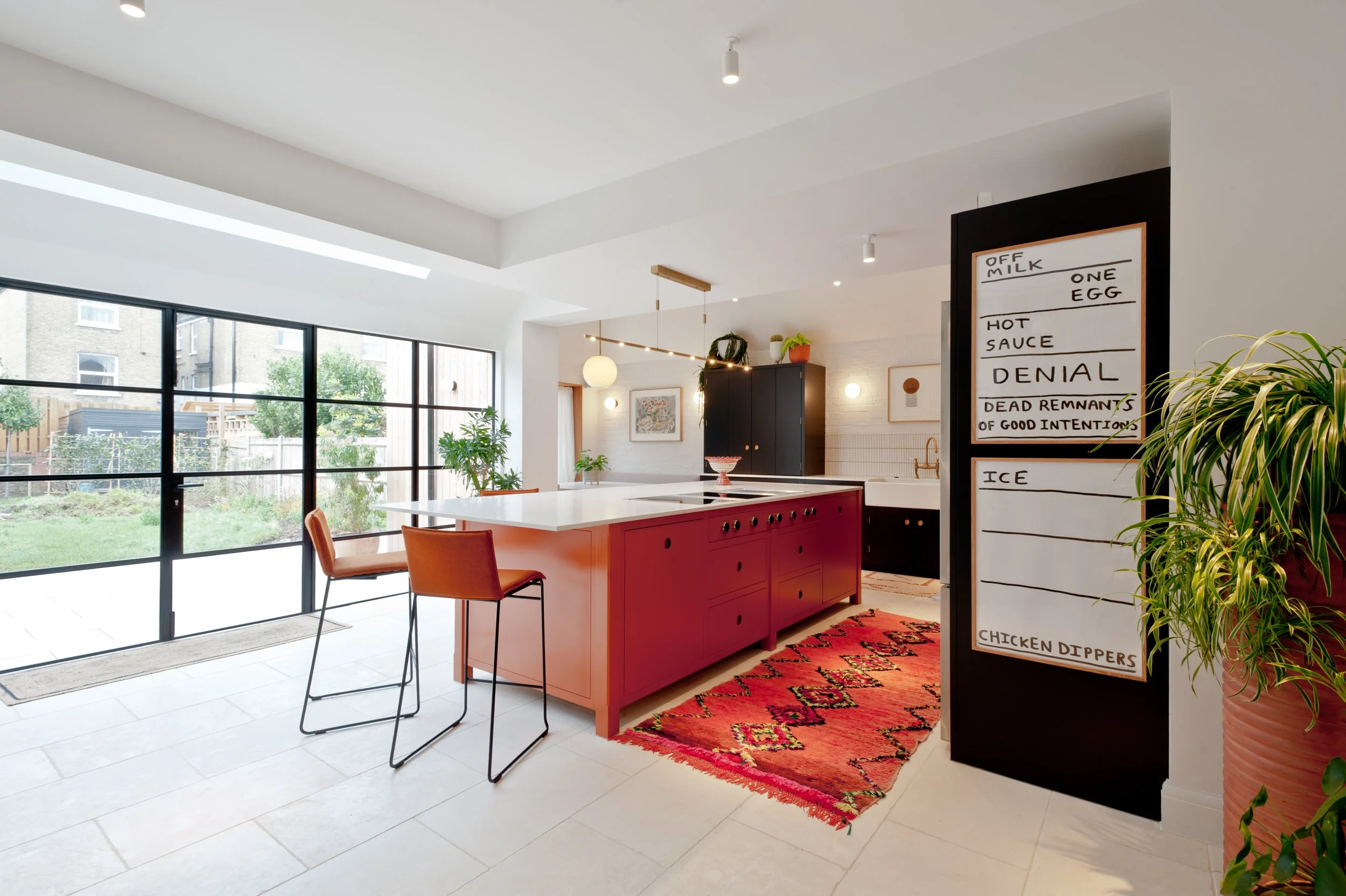 Bespoke orange kitchen with contemporary island in a renovated Victorian home in Margate