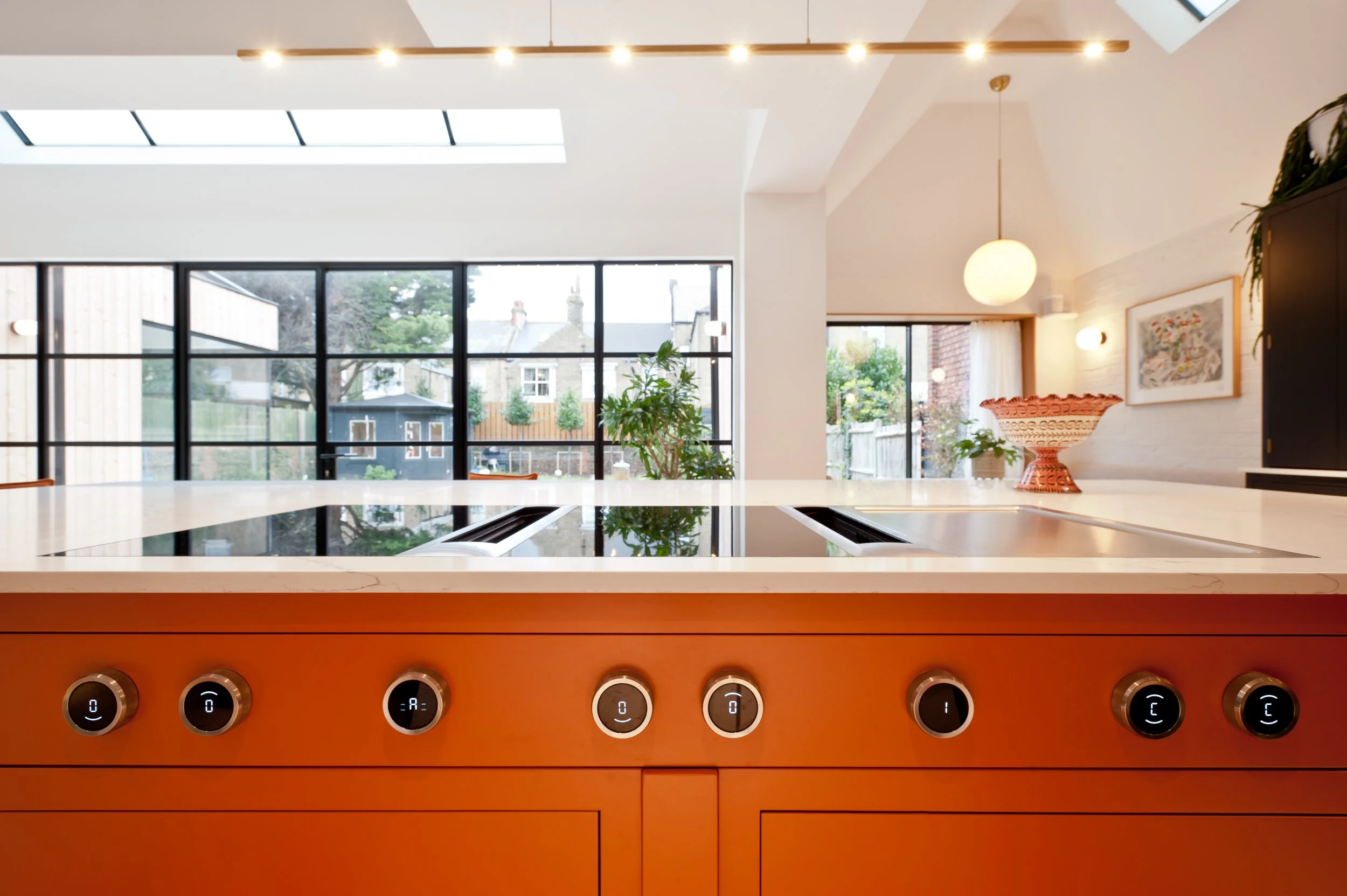 integrated bora hob in painted orange island